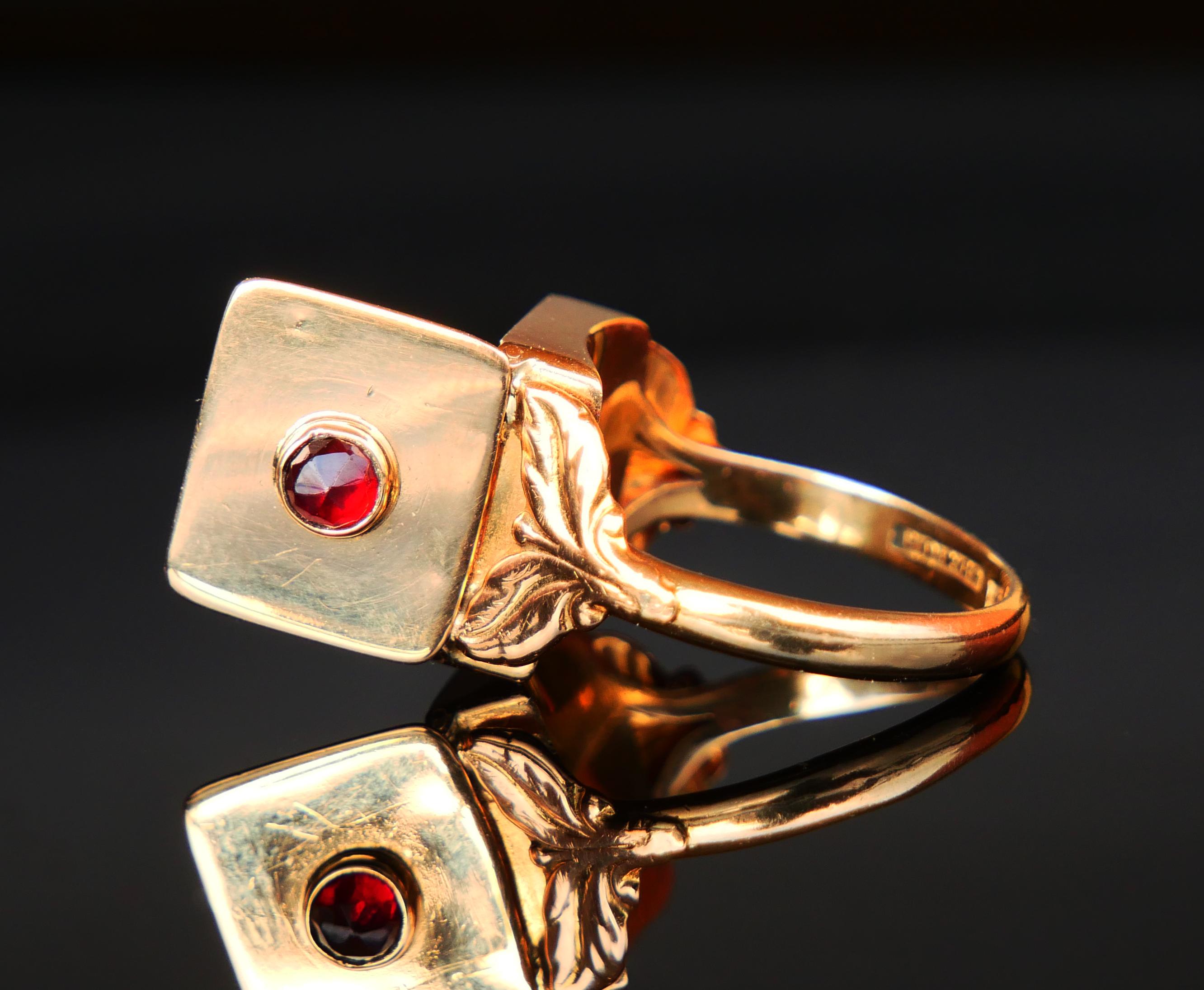 Poison Ring in solid 18K Yellow Gold with crown being a hidden compartment 13 mm x 11 mm x 5.5 mm deep covered with secure and tight hinged lid decorated with rose cut Garnet. Unisex model. 

Made in Sweden in the year 1935 ( mark I8 ). Workshop