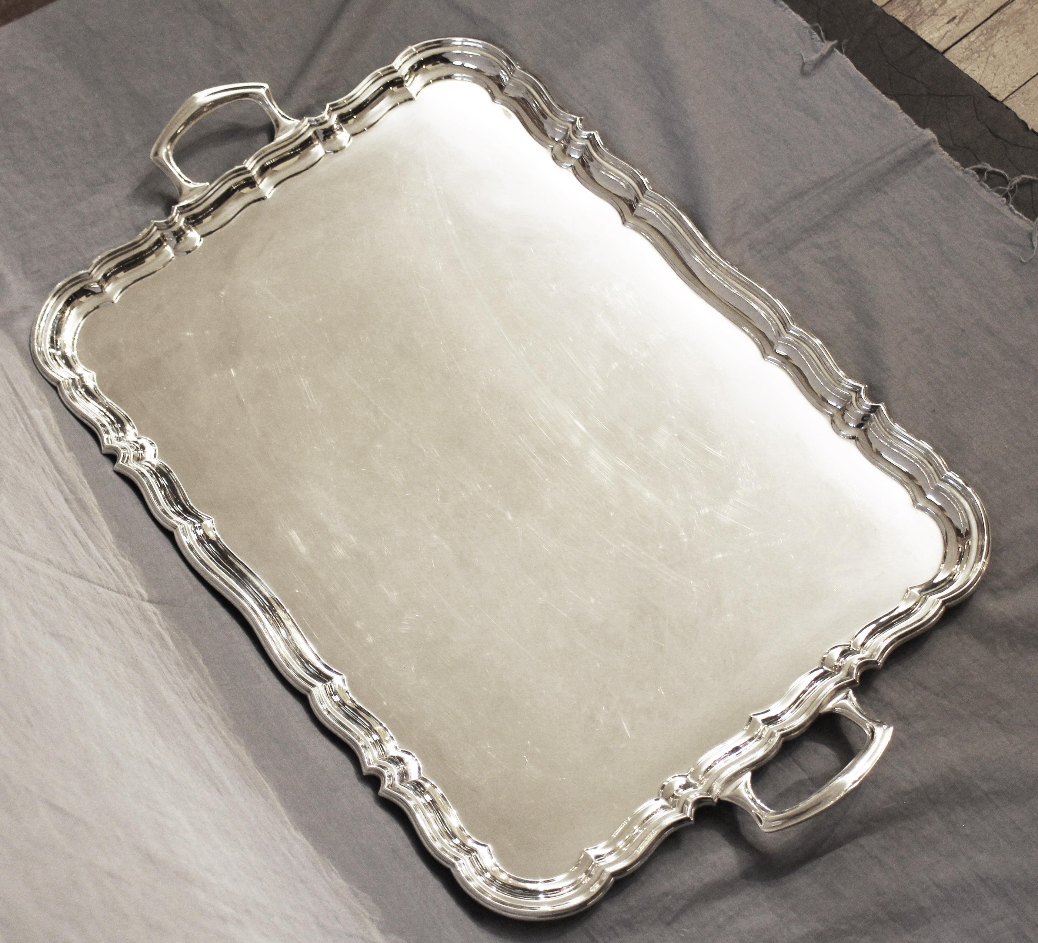 Sterling silver tea tray by Harrison Brothers & Howson in 1935, retailed by Asprey of London. A magnificent piece of undulating form. Made by the renowned Sheffield firm of Harrison Brothers & Howson (George Howson) in 1935 with the Silver Jubilee