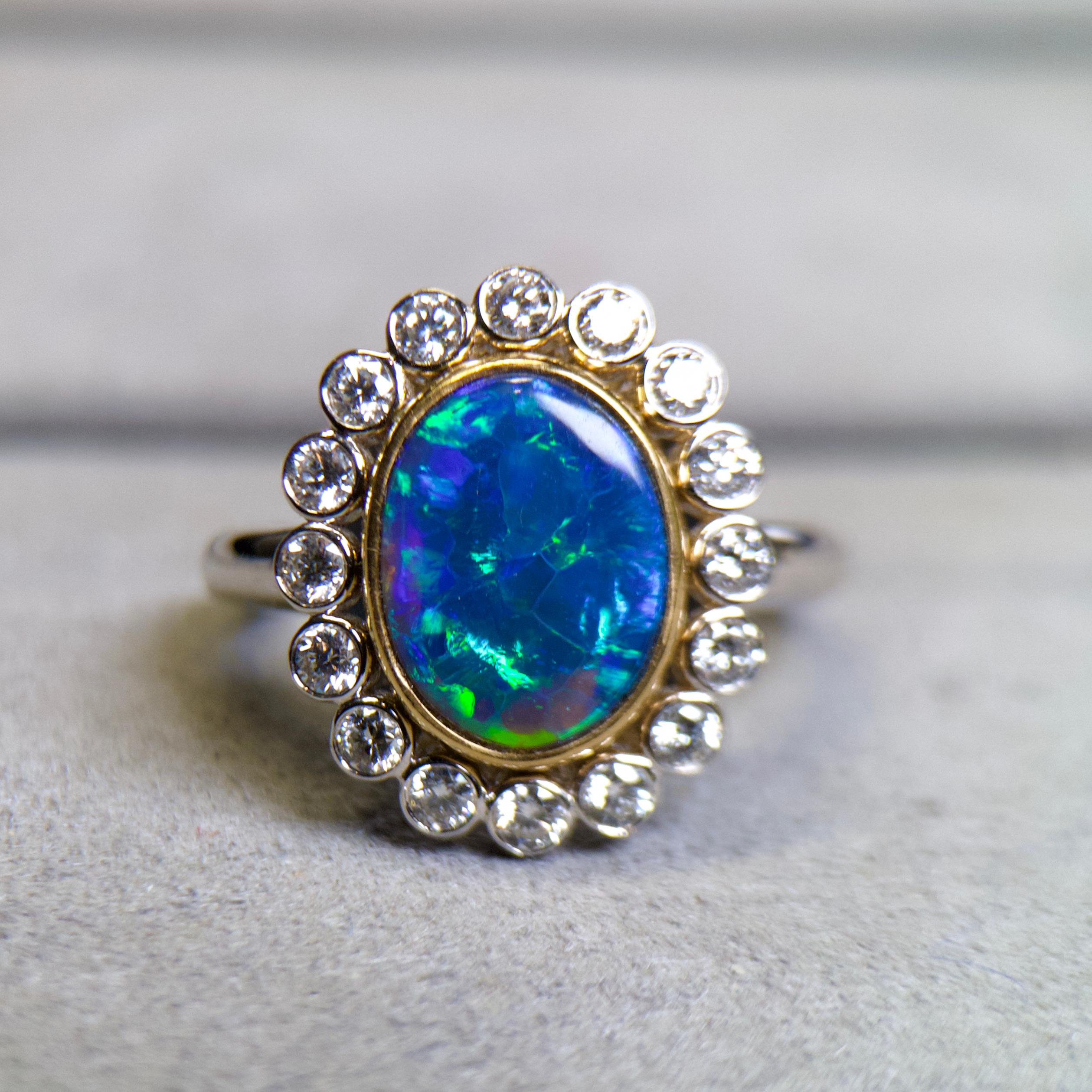 1.935ct Solid Black Opal and Diamond Ring in 18k Gold 

Main Opal Weight is 1.935ct
Total Natural Diamond Weight is 0.56ct, The Colour of the Diamond is Approximately E/F with VS Clarity 

US Ring size is 7