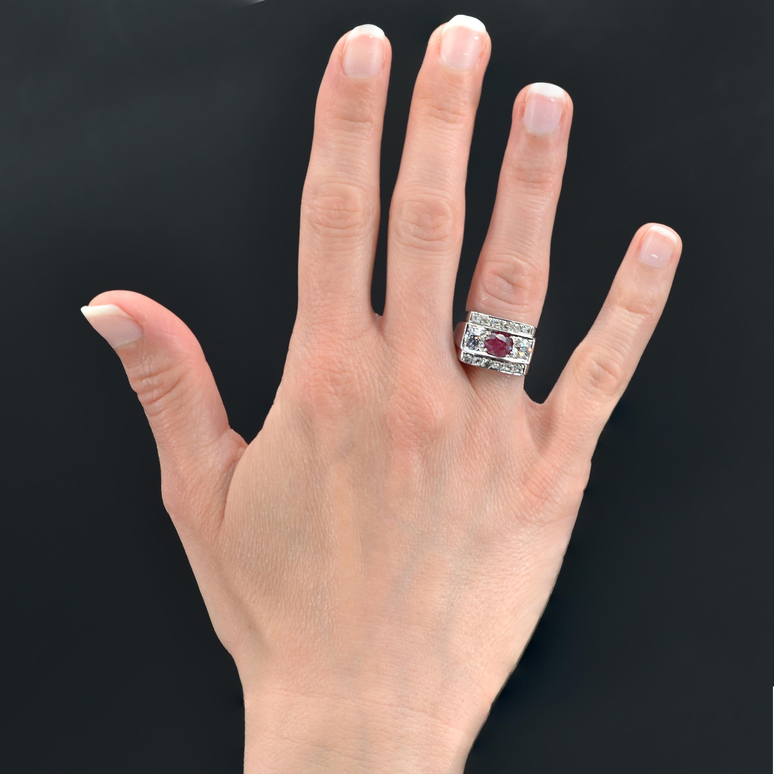 Ring in platinum.
Antique Art Deco ring, it presents a setting with geometric lines adorned in the center of a cushion-cut ruby shouldered by 2 antique brilliant-cut diamonds on both sides. Two lines of 6 antique- cut diamonds border the set. The
