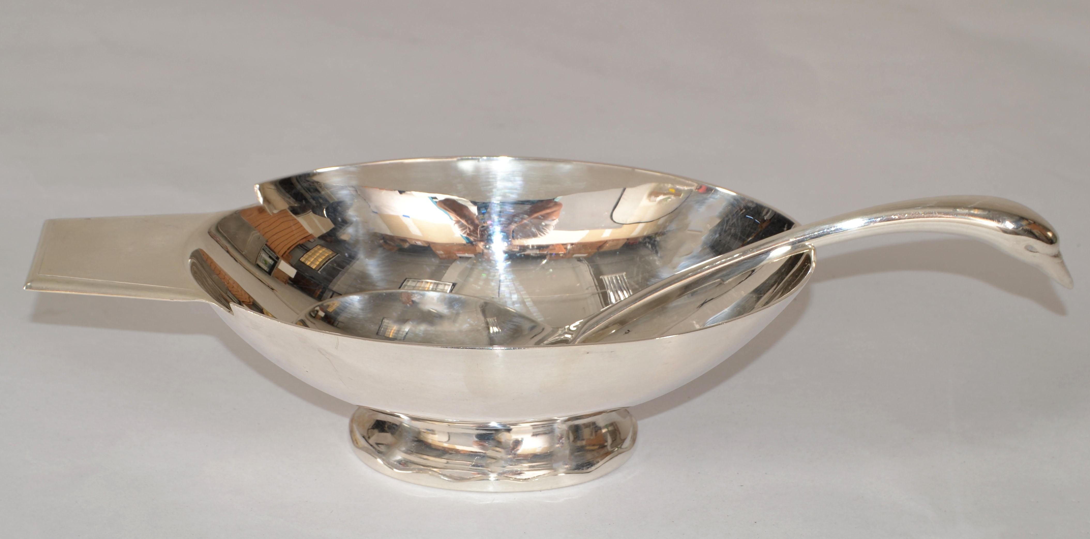 1935 Christofle Art Deco silver plate sauceboat or Gravy Boat with Swan ladle combined conforming to the shape of a swan, Gallia Collection, designed by Christian Fjerdingstad for Christofle, France. 
The Sauceboat on oval shaped footed base with