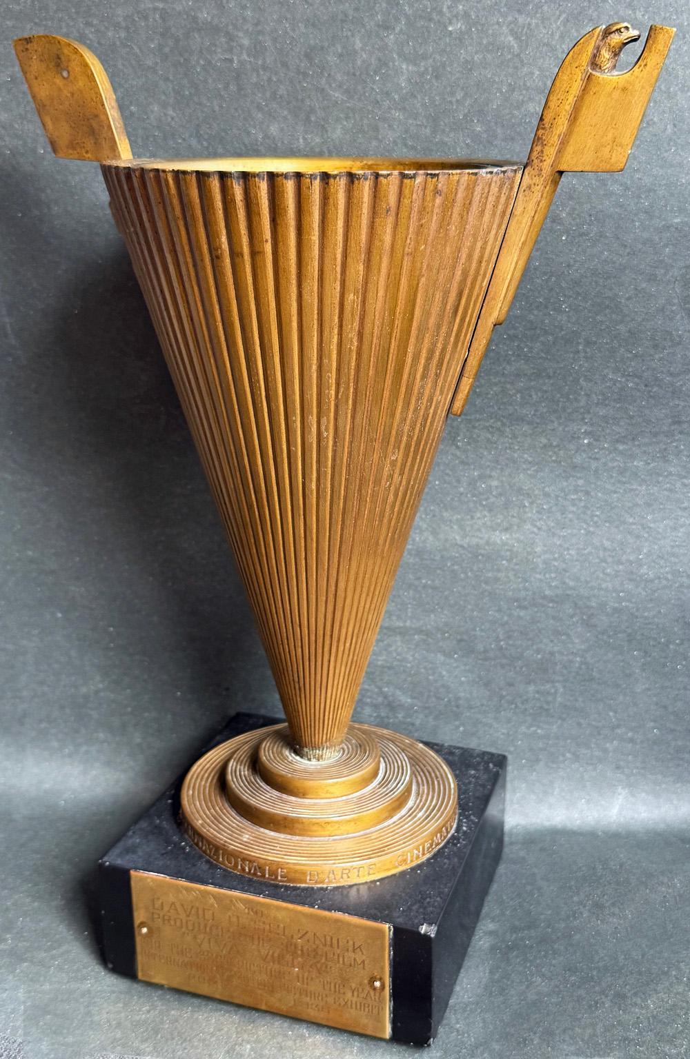 An important symbol of the international success of Hollywood in the 1930s, and a superb example of the Stile Littorio or Italian Rationalist design that prevailed during the rule of Mussolini in Italy, this unique brass or bronze film award was