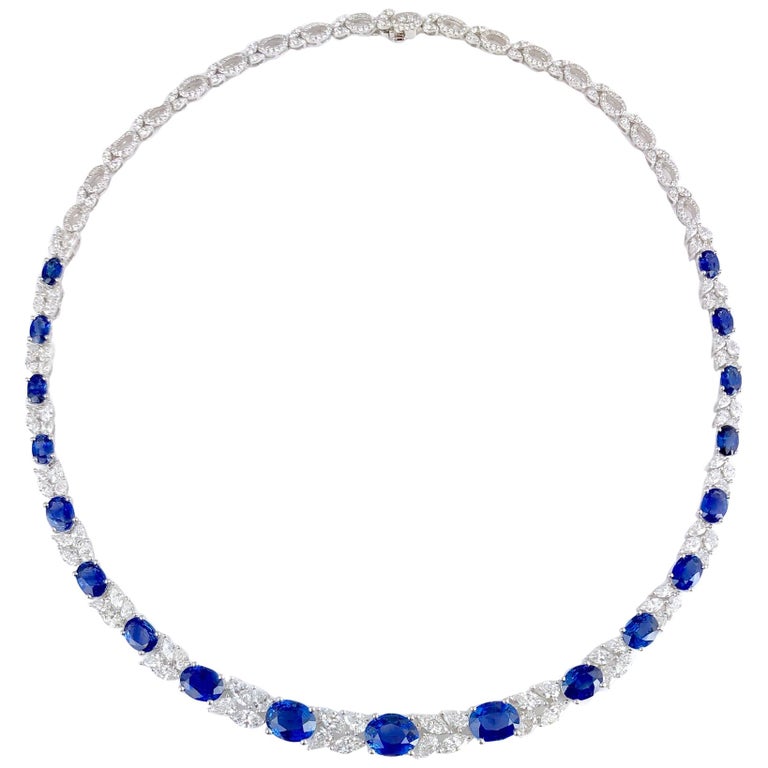 This stunning necklace has 19 oval cut blue sapphires, totaling 19.36 carats. These alternate with clusters of marquise and pear shape diamonds, totaling 8.62 carats. The back of the necklace features an additional 1.85 carats round diamonds.

19