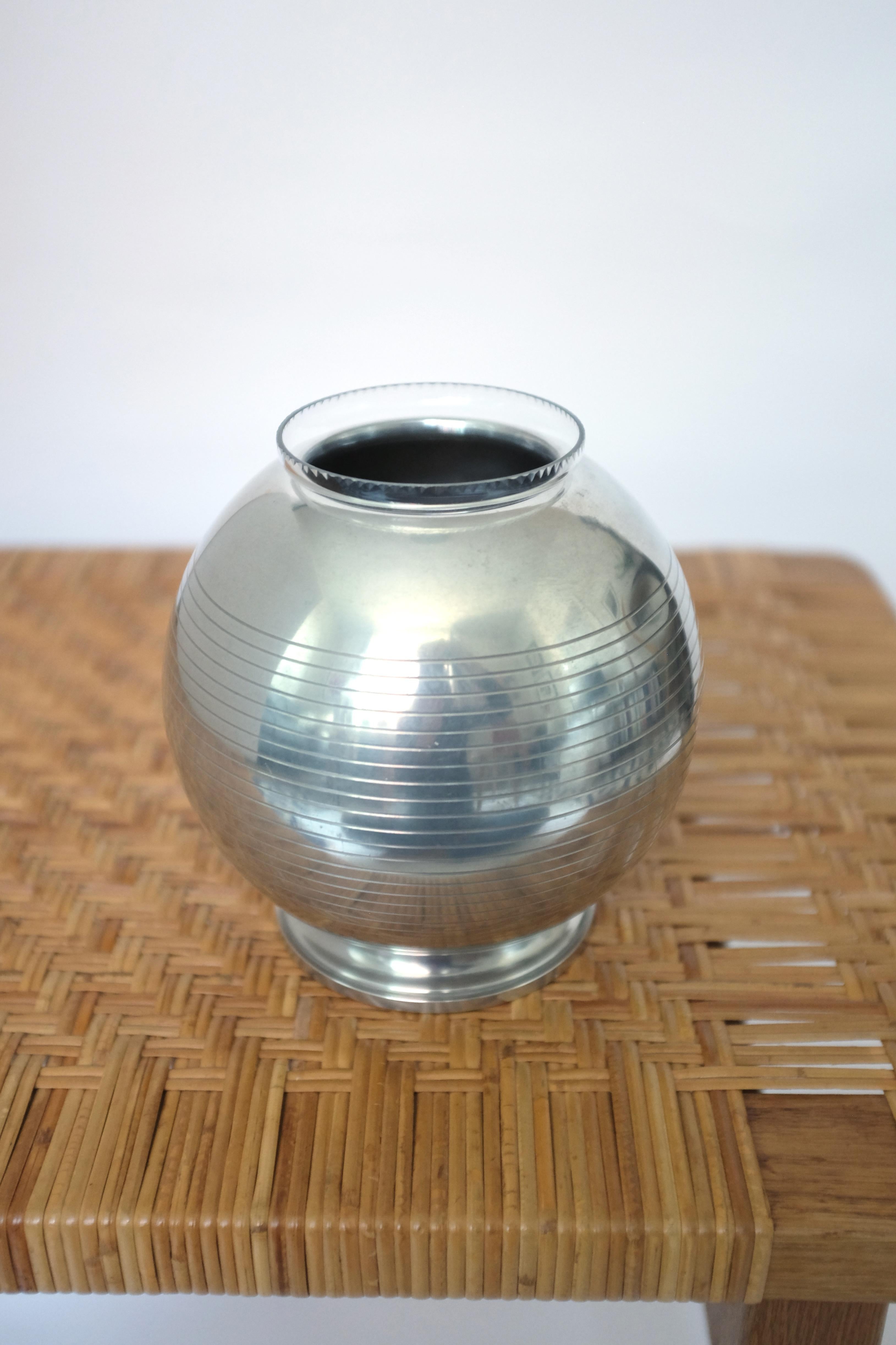 Beautiful round Pewter Vase from 1936 by GAB, Sweden. Very decorative with original glass inserter and carved horizontal lines across the vase. In a good vintage condition with age appropriate wear and dents (please see photos). GAB was a Swedish
