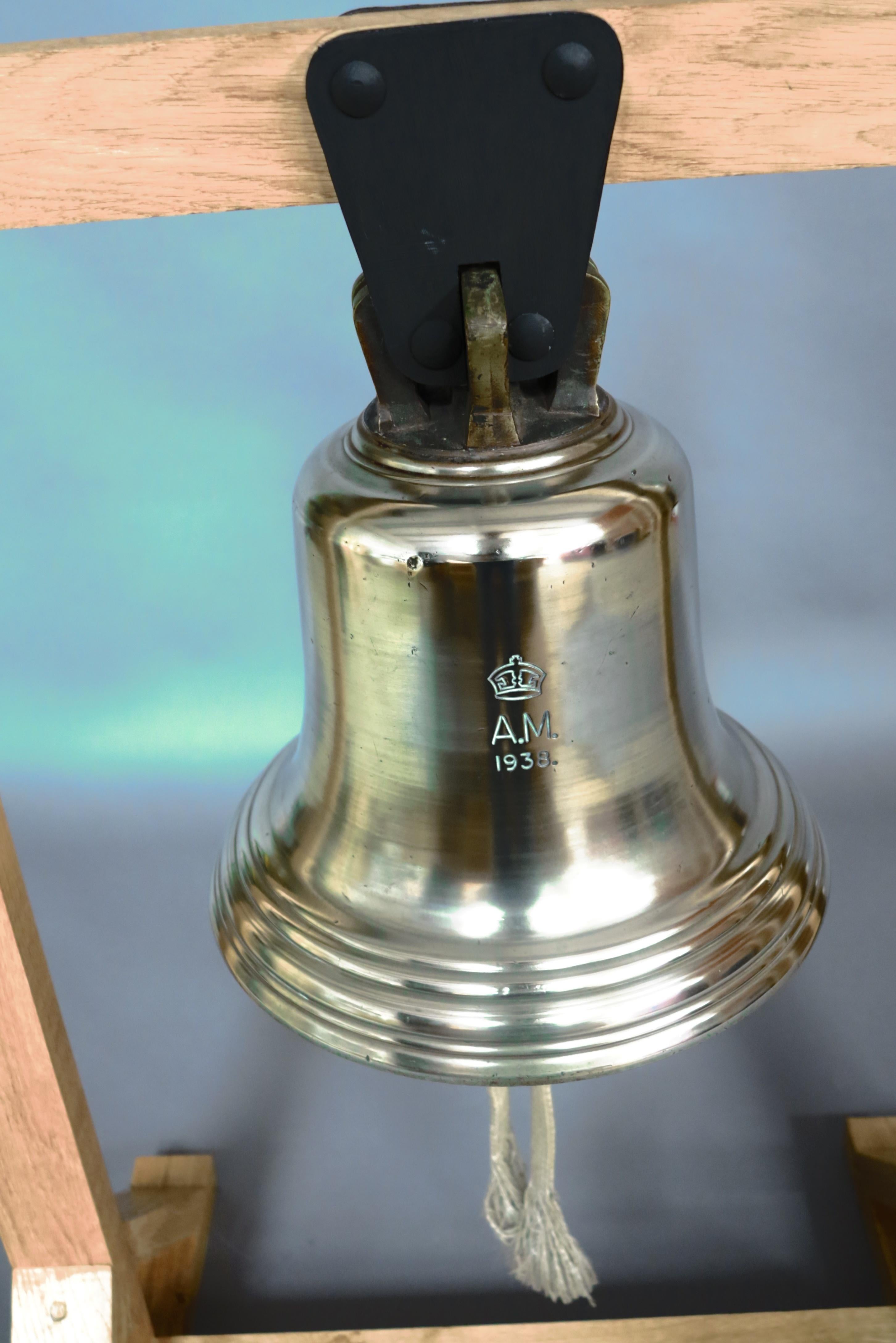 A majestic Royal Air Force station large bronze ‘scramble’ bell, in service at the start of World War II, mounted from on a custom oak frame, retaining its original clanger. The casing marked with engraved AM (Air Ministry) crest and crown above,