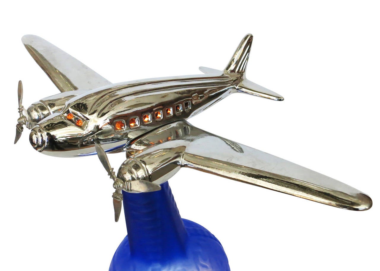 This custom chrome airplane accent lamp was created in Los Angeles in the 1980s using a re-edition 1939 cobalt blue World's Fair vinaigrette bottle. The 1939 vinaigrette bottle was re-purposed for the center of the design with an added chrome base