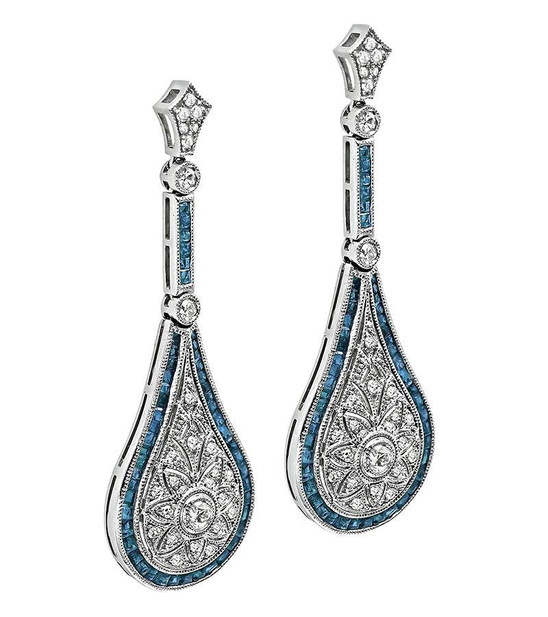 This is a gorgeous pair of platinum drop earrings. The earrings feature sparkling old mine and round cut diamonds that weigh approximately 0.68ct. The color of the diamonds is G-H with VS2 clarity. The diamonds are accentuated by lovely square cut