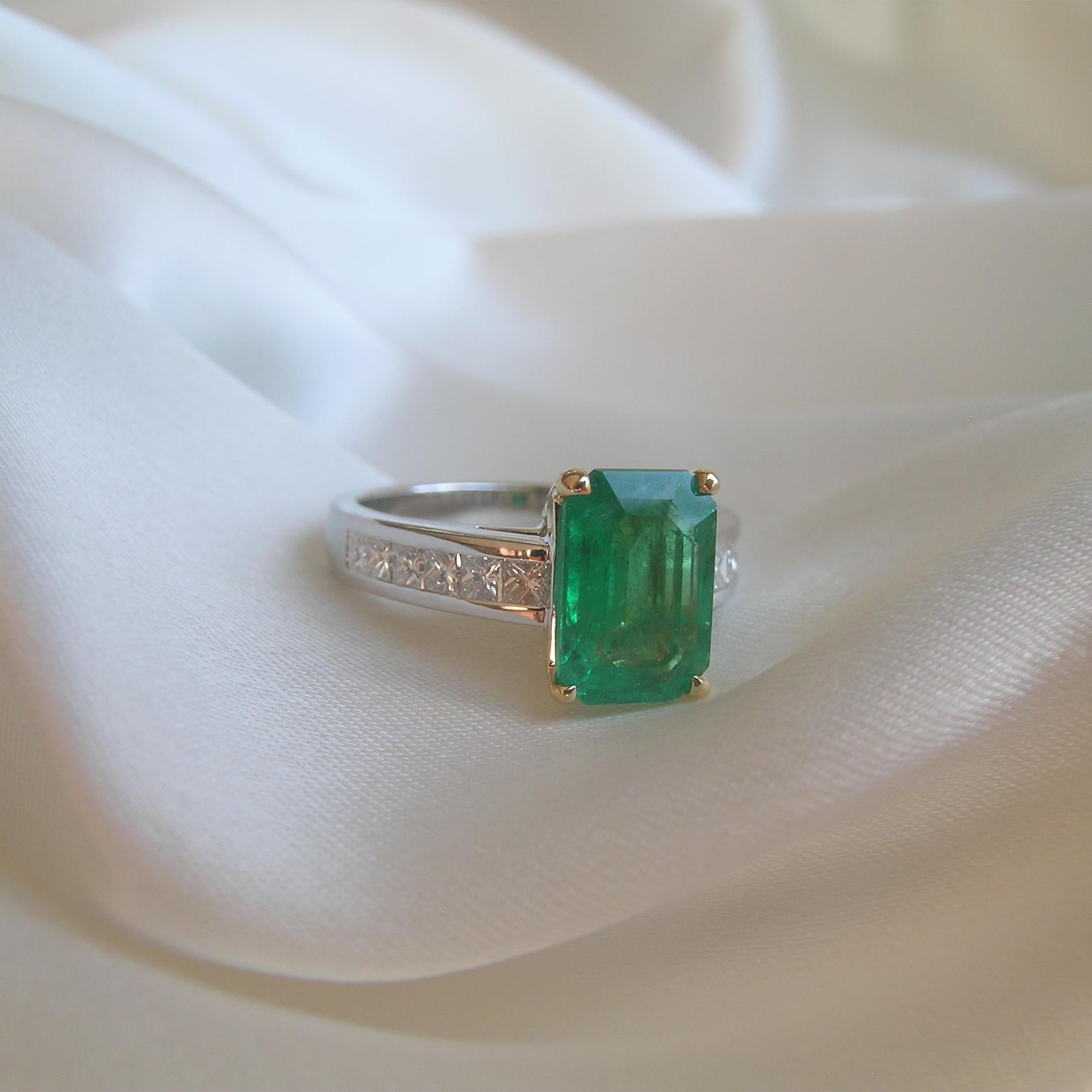 This small, very high quality Emerald is the showcase for this 18k White and Yellow Gold Cocktail Ring.
The  diamonds are channel set creating a sparkling back ground for the Emerald.  A classic example of every day luxury, this ring is meant to be
