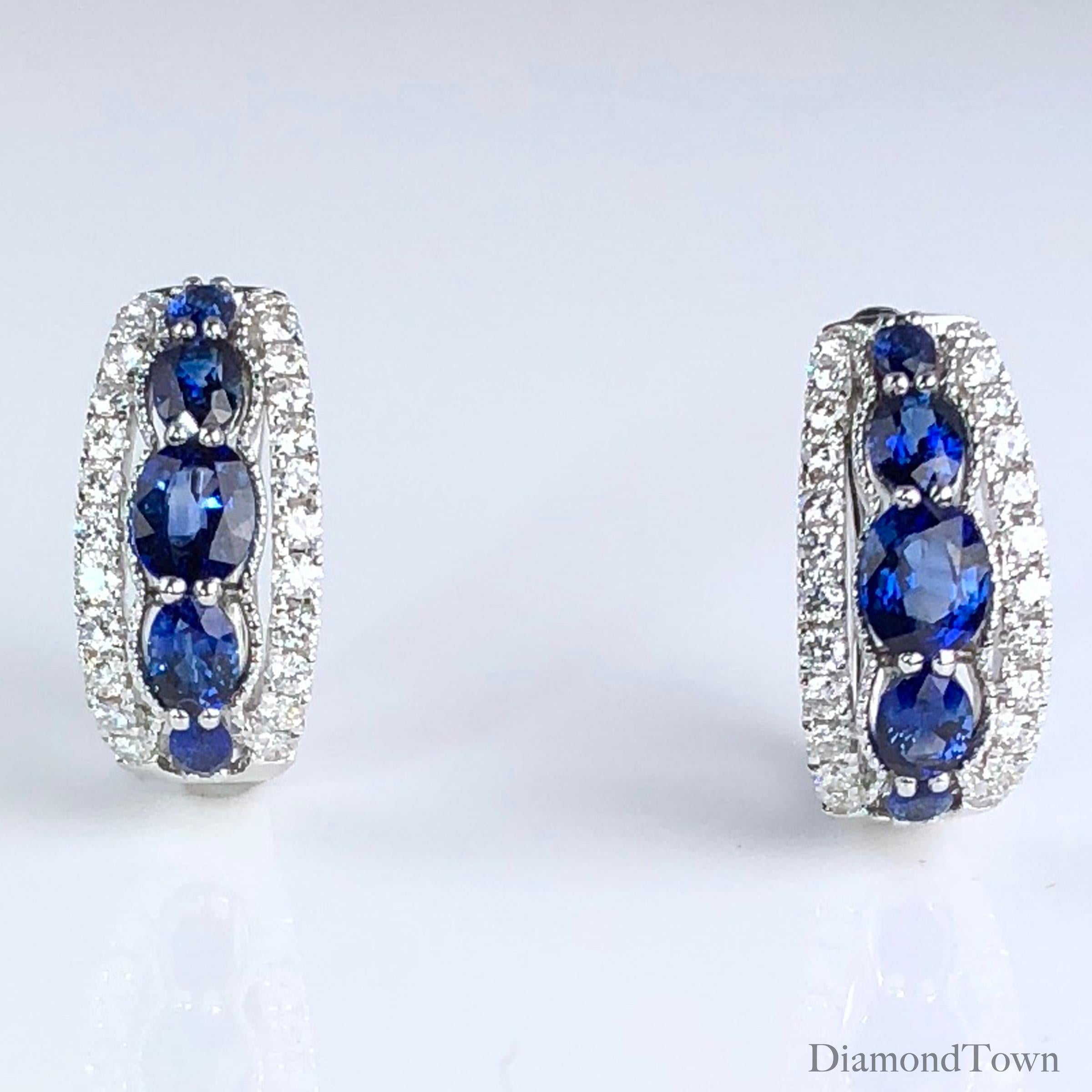 These earrings feature 5 graduated oval cut sapphires each (total weight 2 earrings 1.94 carats), wrapped on both sides with white diamonds (total diamond weight 0.54 carats). The earrings close securely by lever-back, and are set in 18k white