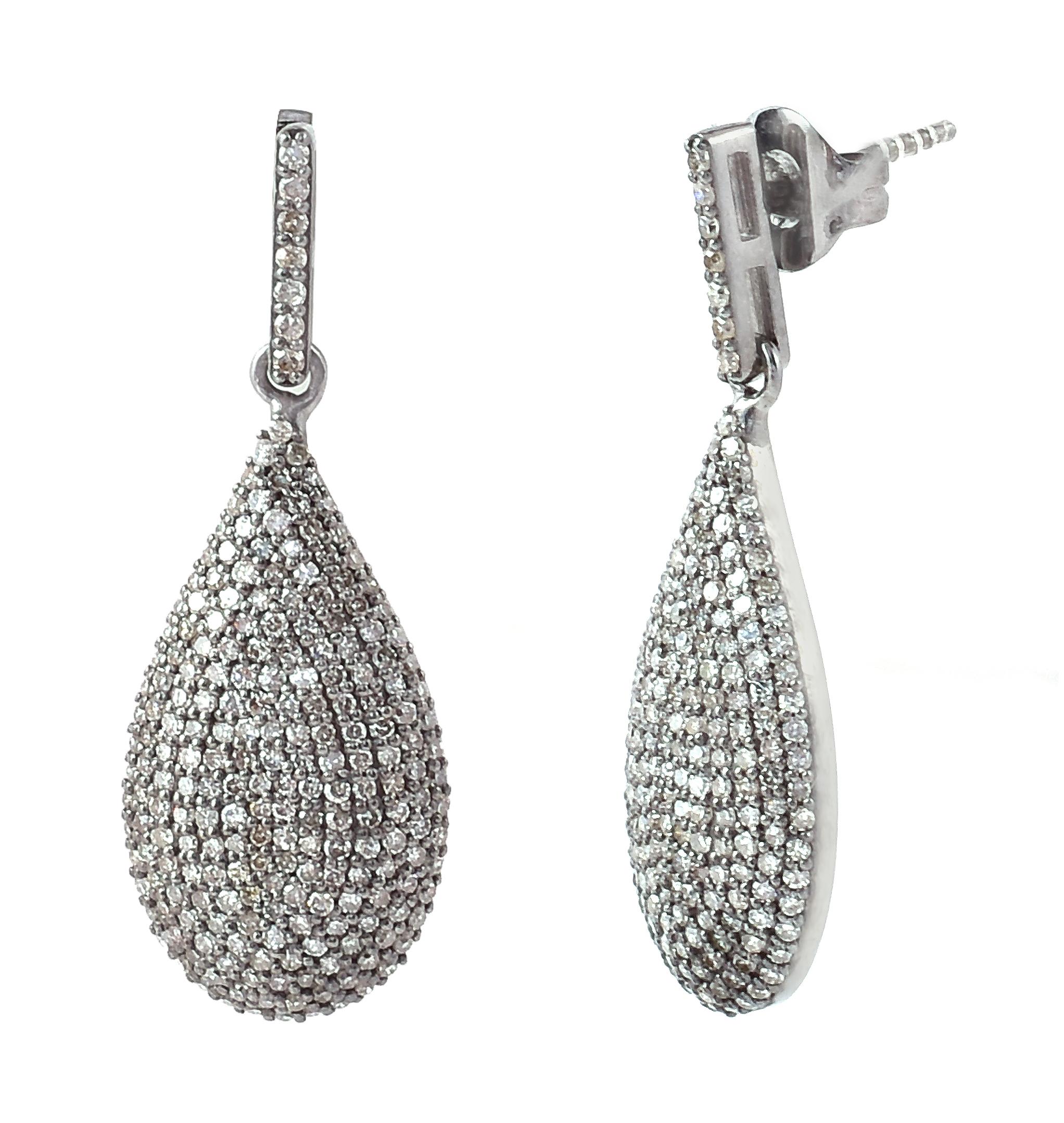 1.94 Carat Diamond Dangle Earrings in Victorian-Style

This Victorian art-deco style diamond pave set hanging earring is exquisite. The bottom pear drop is magically formed with several pave set diamond rows gradually increasing from the center