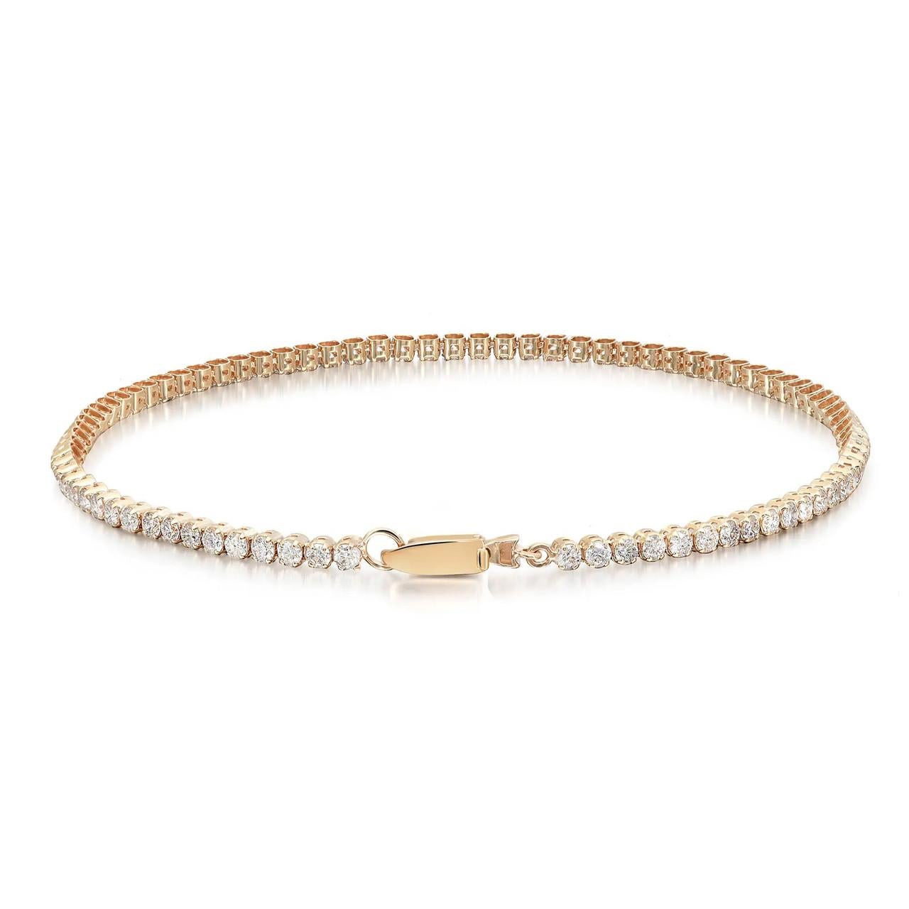 Elevate your wrist with the brilliant charm of this prong-set round brilliant cut diamond tennis bracelet, skillfully crafted in 14K yellow gold. The captivating sparkle effortlessly infuses a touch of glamour into any ensemble. Designed for easy
