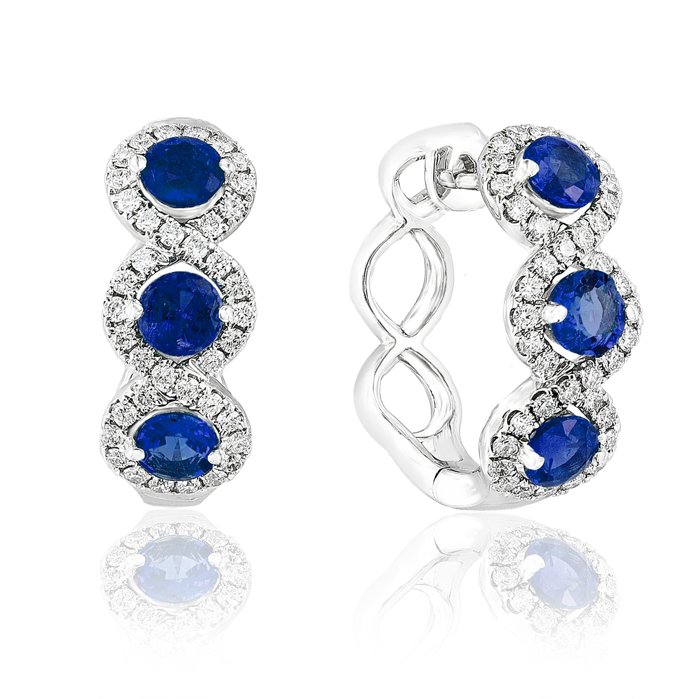 A chic and fashionable pair of hoop earrings showcasing brilliant-cut 6-round blue sapphire weighs 1.94 carats in total, set in 18k white gold.  76 Round diamonds surrounding the blue sapphires weigh 0.65 carats in total. A beautiful piece of