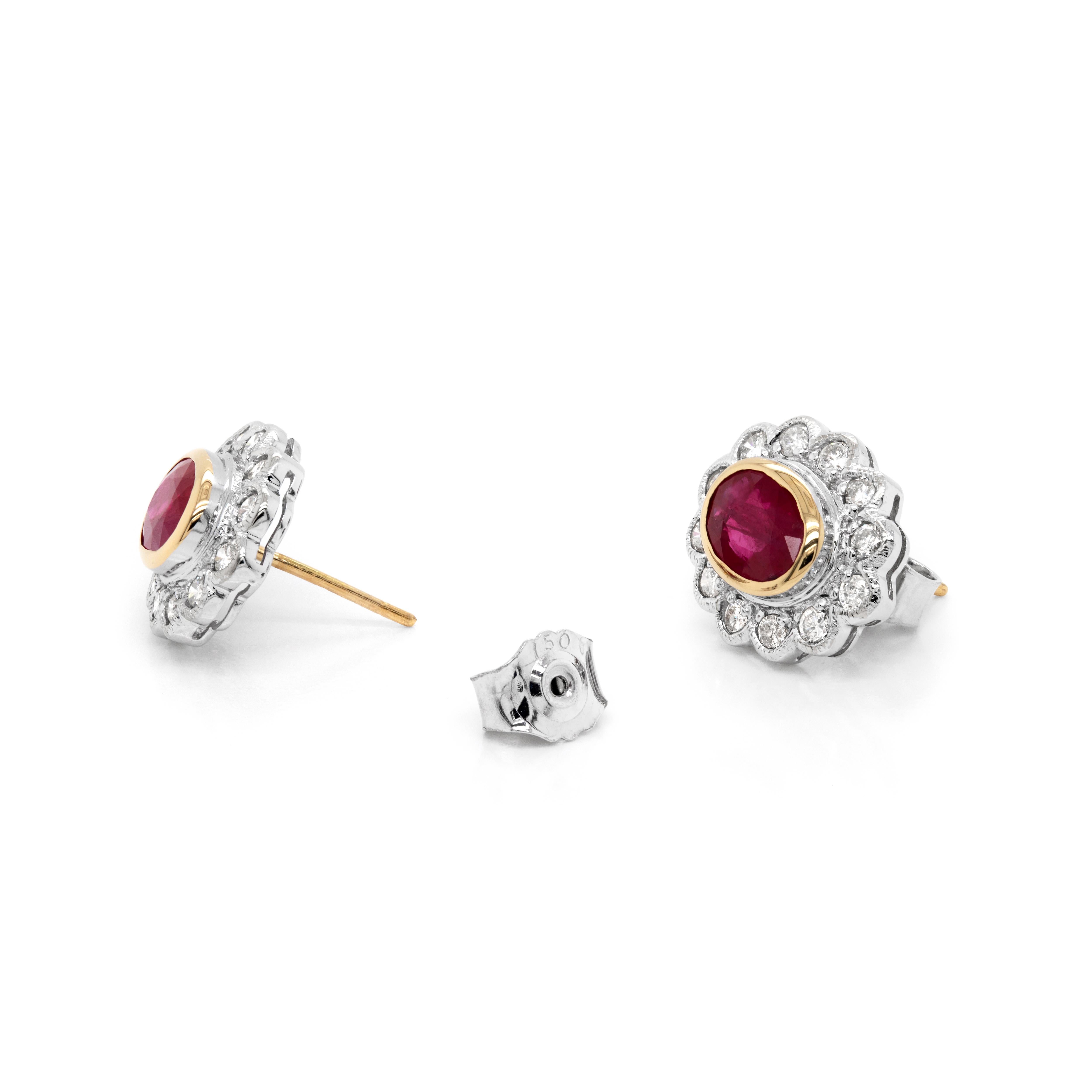 These beautifully rich stud earrings are each rubover set with a gorgeous oval ruby weighing a combined 1.94 carats mounted in 18ct yellow gold open back settings. The gemstones are perfectly surrounded by 12 fine quality round brilliant cut
