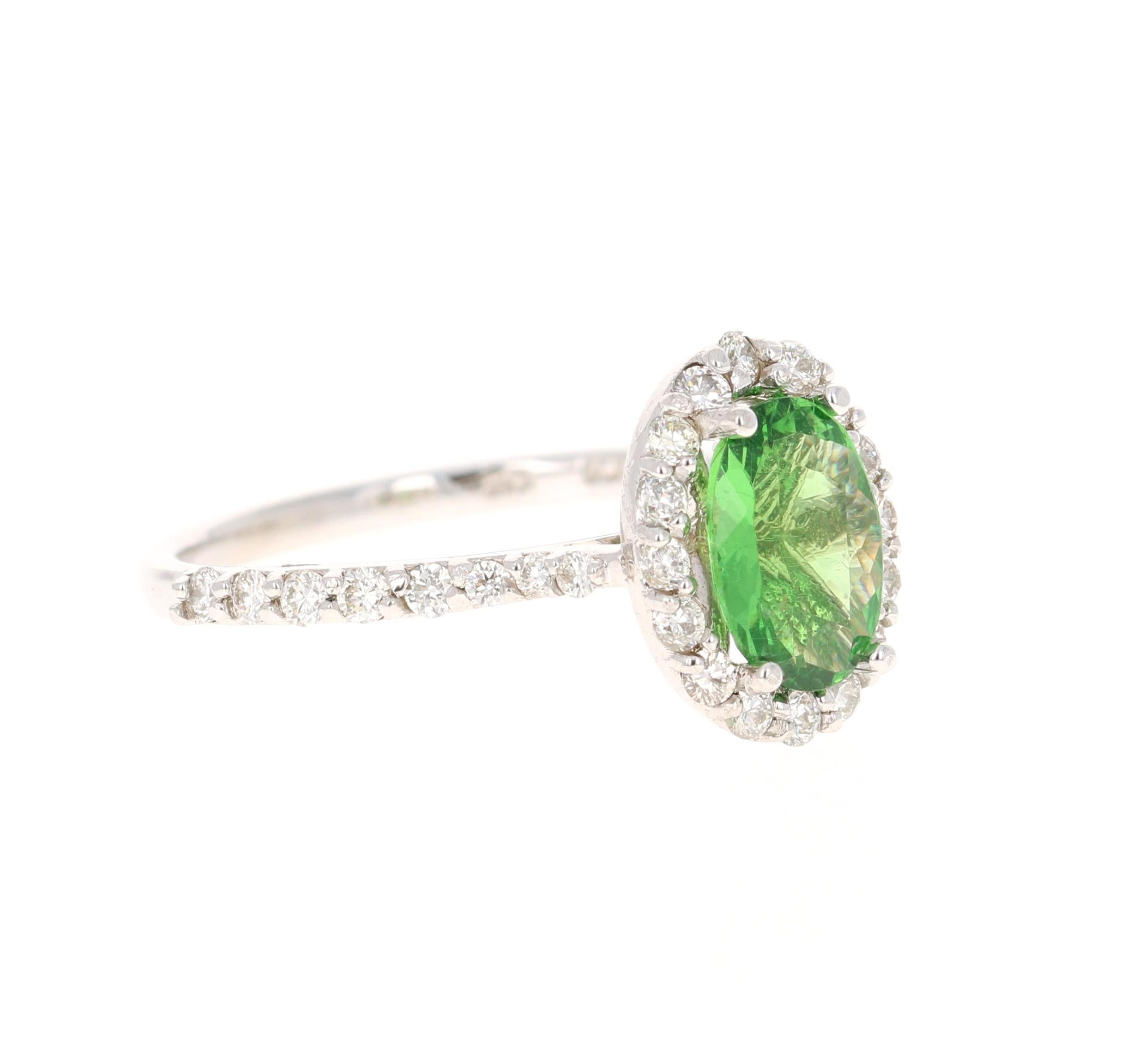 This ring has an Oval Cut Tsavorite which weighs 1.35 carats and is surrounded by a halo of 32 Round Cut Diamonds that weighs 0.59 carats. The total carat weight of the ring is 1.94 carats. The clarity and color of the diamonds are VS-H.

The ring