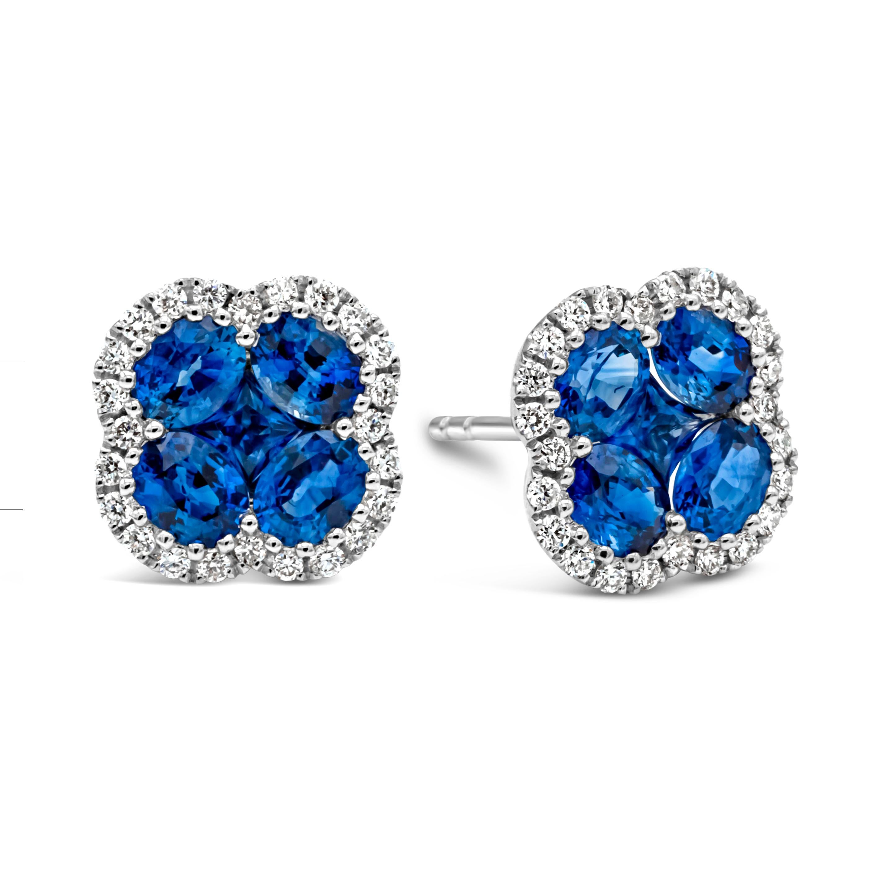 A simple and chic pair of stud earrings showcasing a cluster of oval and princess cut brilliant blue sapphires weighing 1.94 carats total, arranged in a beautiful clover design and shared prong setting. Surrounded by a single row of round brilliant
