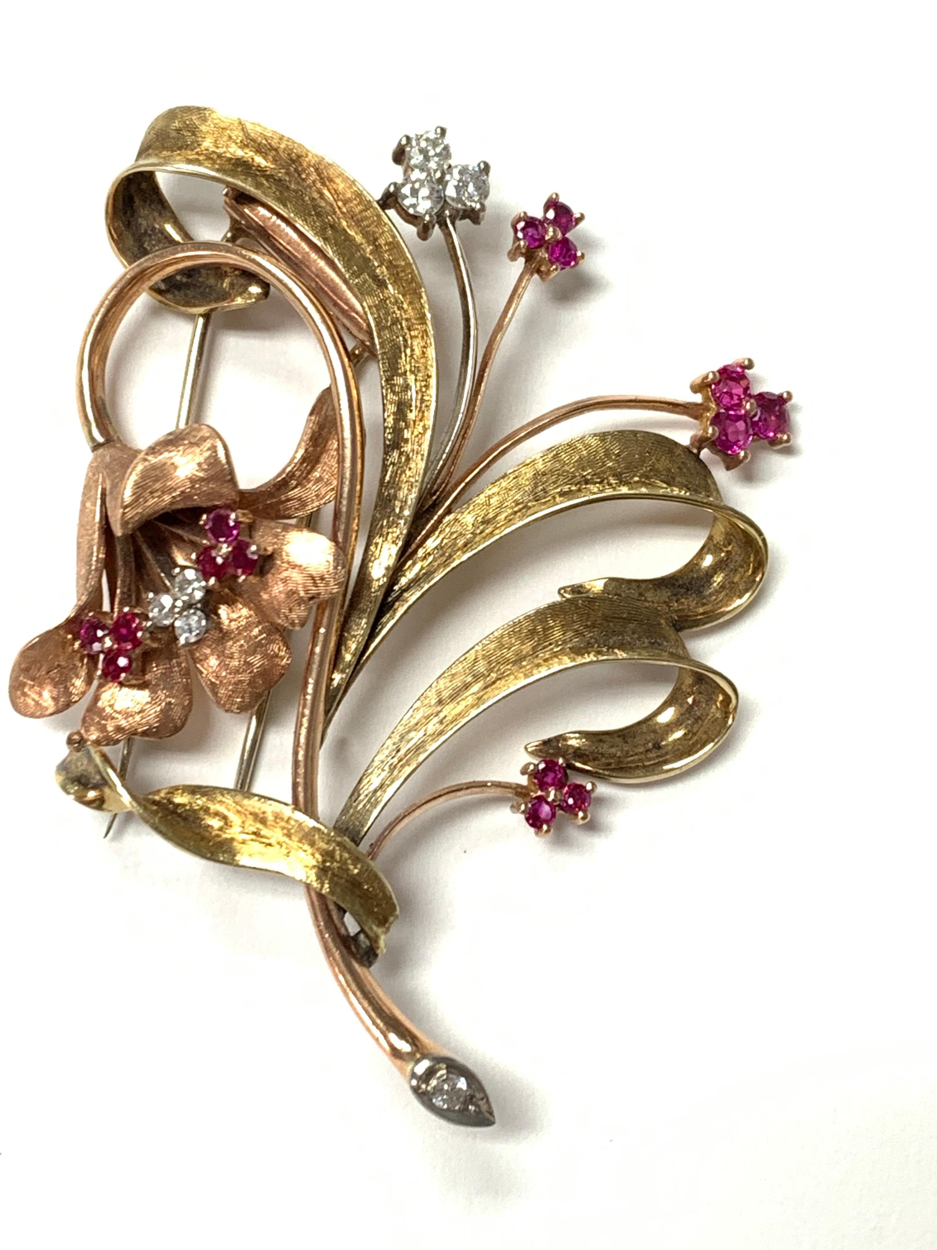 Diamond and Ruby brooch beautifully handcrafted in yellow gold. 

The details are as follows: 
Diamond weight : 0.50 carat ( H color and VS2) 
Metal : 14K Yellow Gold 
Measurements : 3