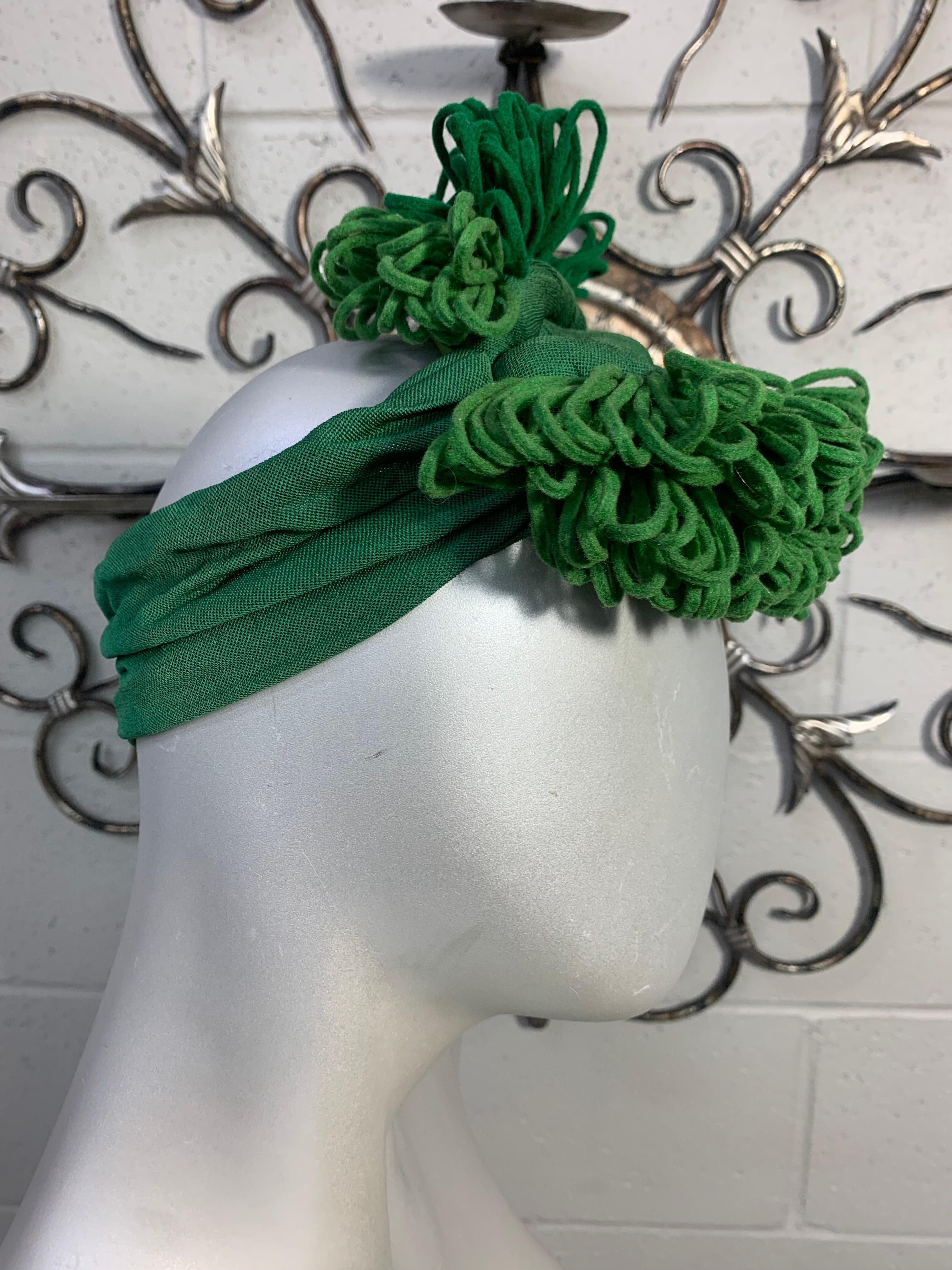 A wonderful and rare early Bes-Ben tilt hat in a rich Kelly green: Front consists of exuberant loopy felt fringe. The back is a wide wrapping jersey band securing hat to head. A true fascinator! One size. 