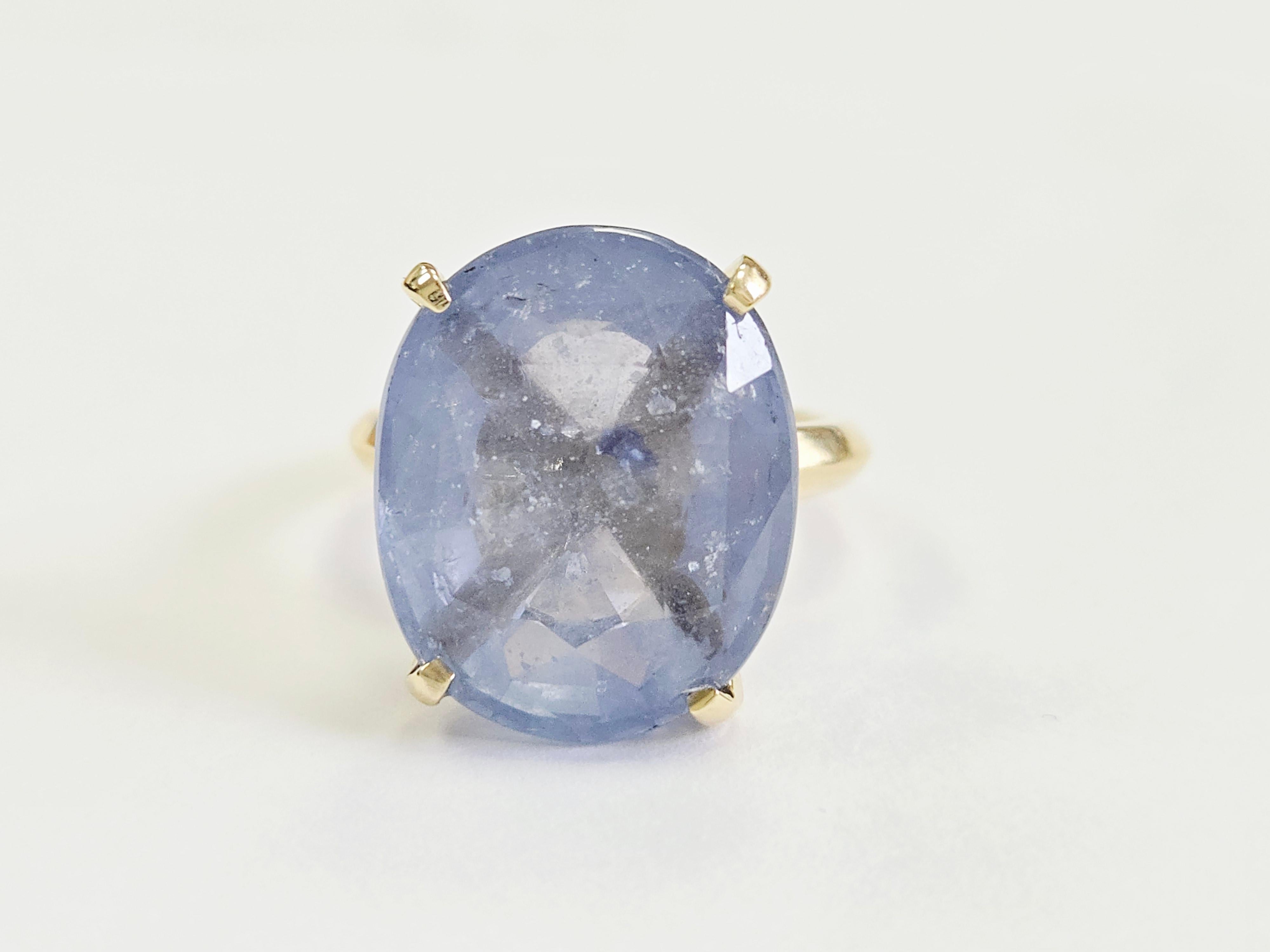 Elevate your collection with this exquisite 19.40 carat oval pastel sapphire ring, a rare and luminous statement piece set in rich 14 karat yellow gold. The sapphire’s delicate pastel hue exudes soft elegance, showcasing exceptional clarity and a