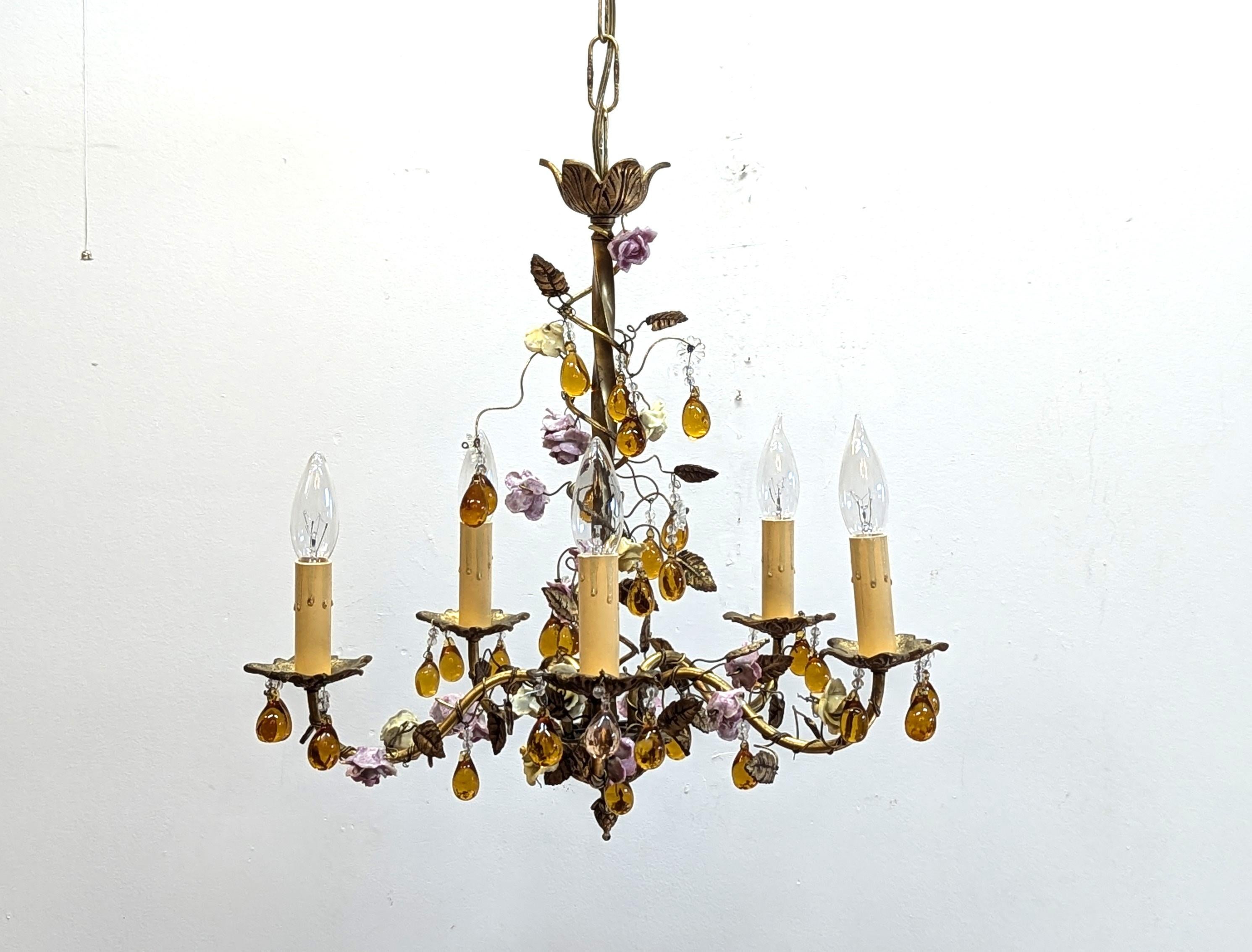 Charming French Tole Bronze Ceramic Flower Chandelier.  Brass & Bronze Tole Chandelier all handcrafted adorned with handmade ceramic flowers of yellow and purple having amber glass droplets and cut glass beads.  A beautiful vintage French fixture. 