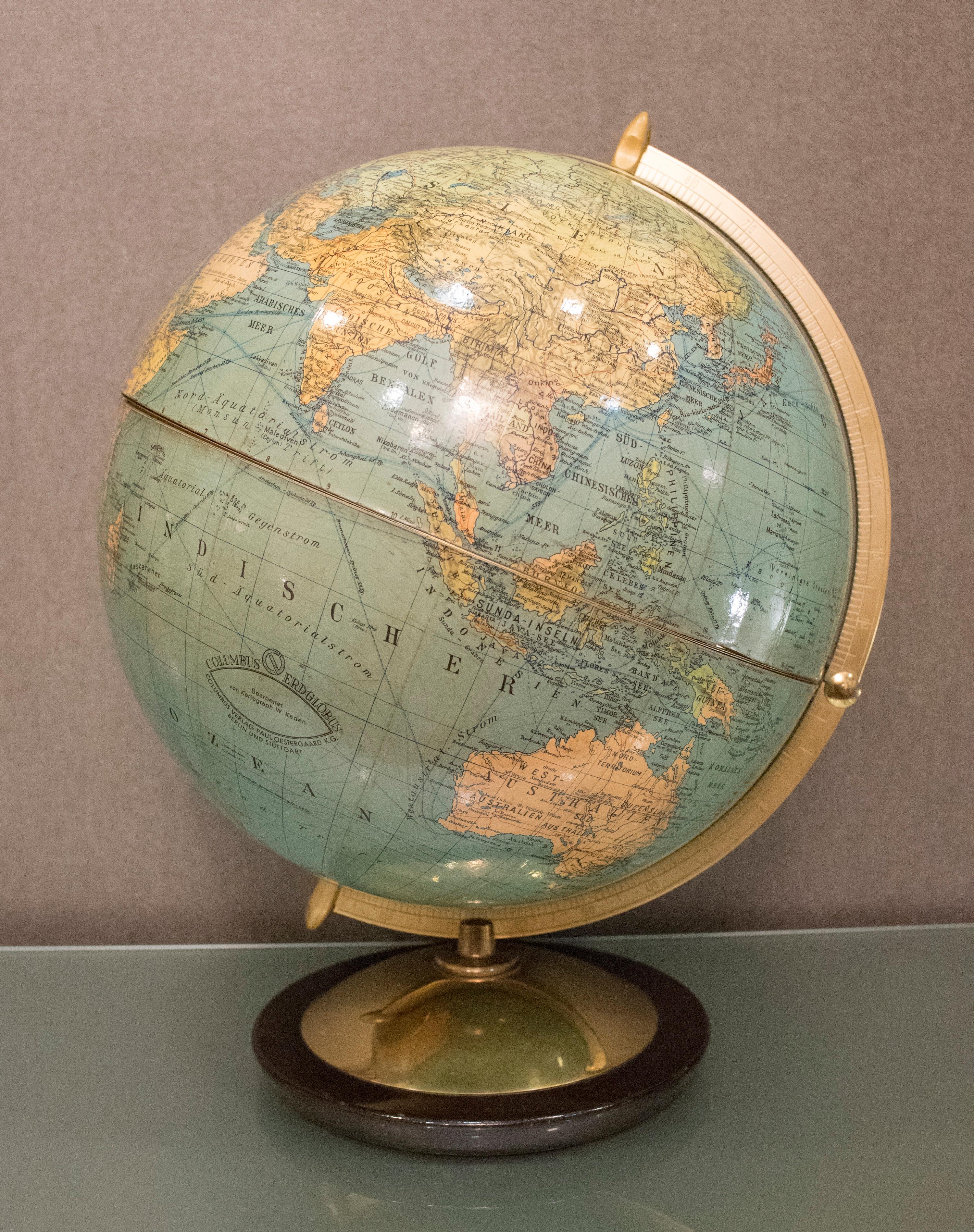 An amazing real earth globe from Columbus Verlag, Berlin, 1940 Bauhaus style, later transformed by Dejavu (French Maison) into a bar cabinet, it still has the original bottle and crystal glasses. Inside is lined in champagne color silk.
The