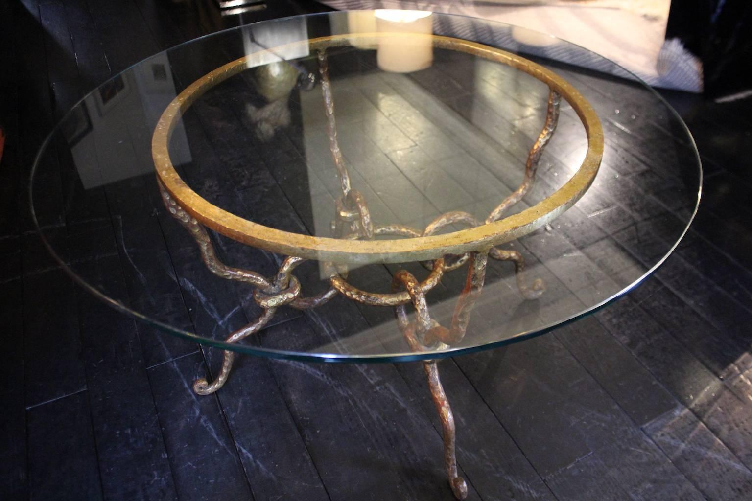 Gold round coffee table hand-forged iron, transparent glass top, 1940.
