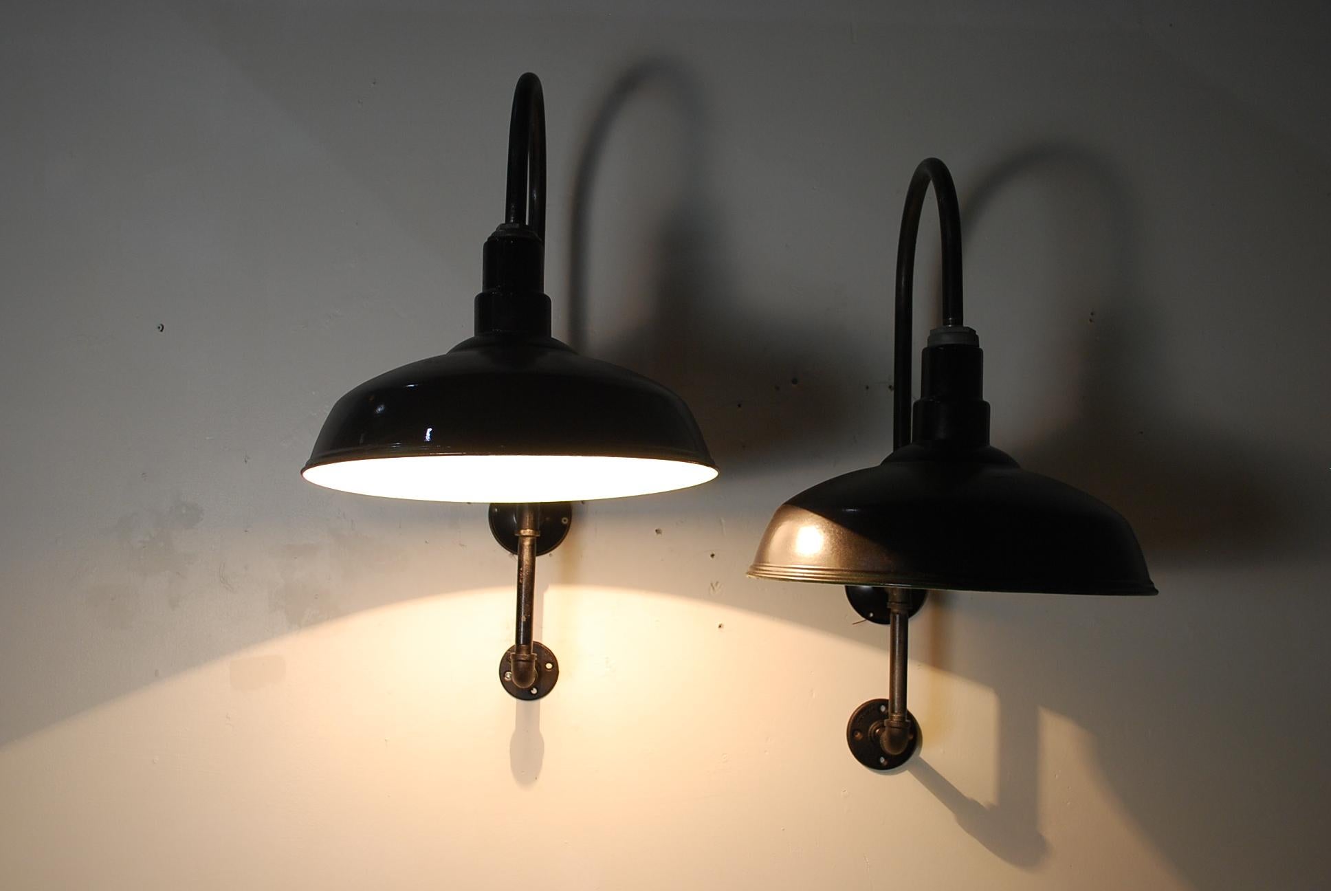 Rewired and compliant pair of industrial sconces connected to bespoke pipe configuration for easy set up.
The enamel shades are in a black finish ..with white underneath.
Regular bulb all ready to install.
