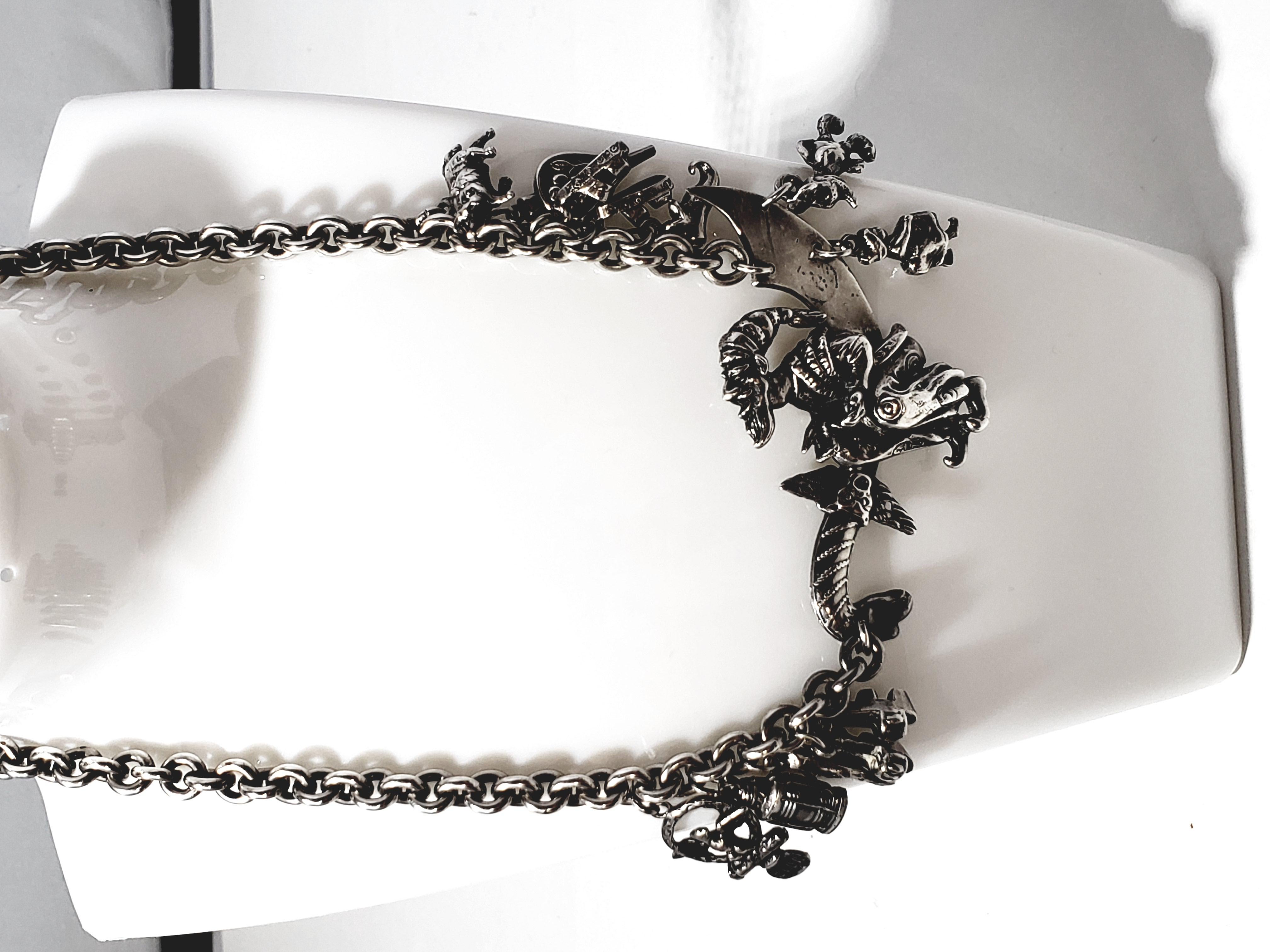 1940 Korda Thief of Bagdad Charm Choker Necklace

An incredibly detailed piece from the 1940’s by famed jeweler, Korda.  This sturdy chain features dangling charms. The central piece is the Thief of Baghdad, perched on a dragon-headed ornate