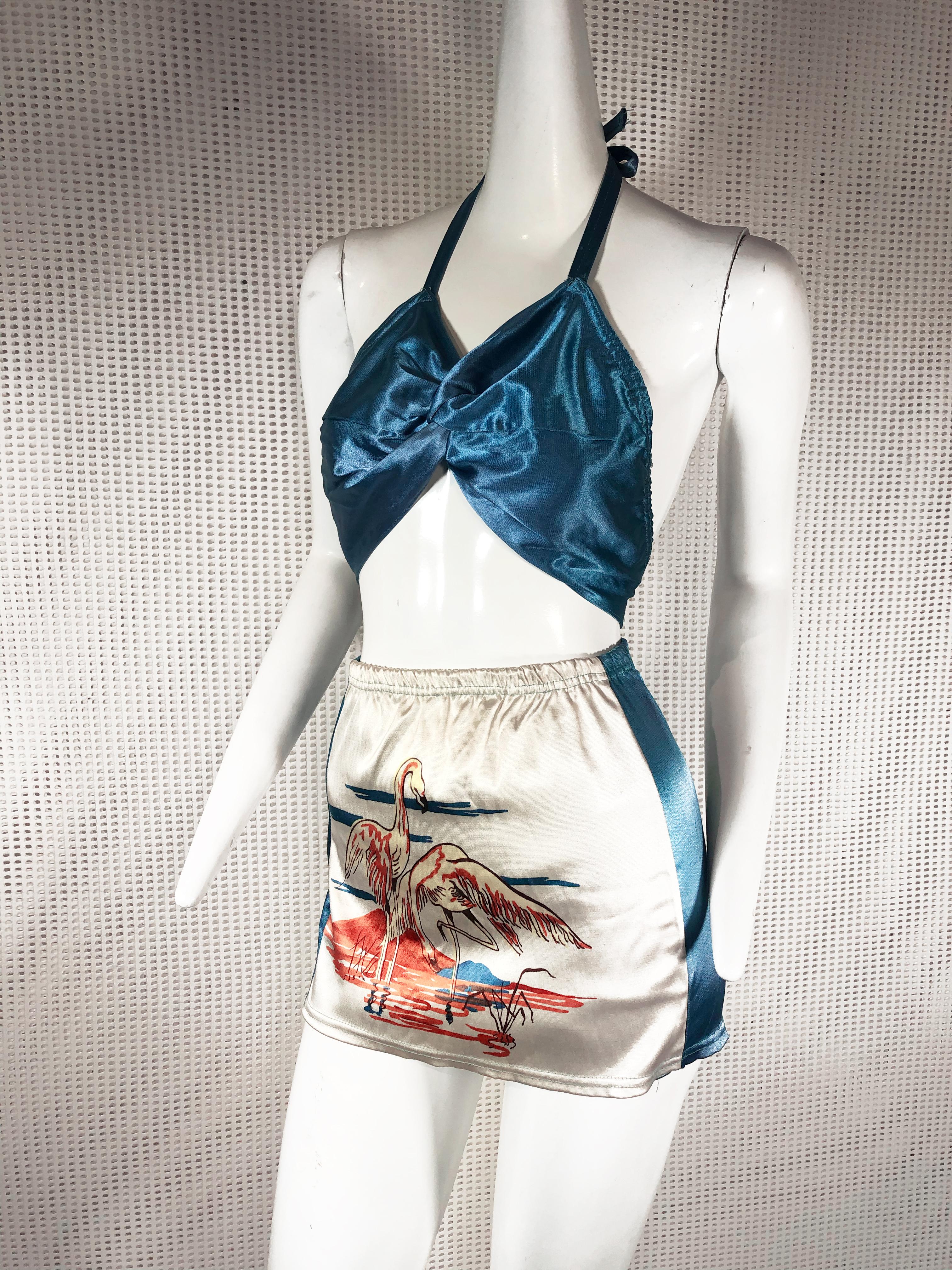 1940s Hollywood style flamingo print 2-piece Pin-Up swimsuit / playsuit: halter tie top and skirted, high-waisted bottoms in azure blue and white satin. Size Medium. No zipper, pull-on. Excellent condition.