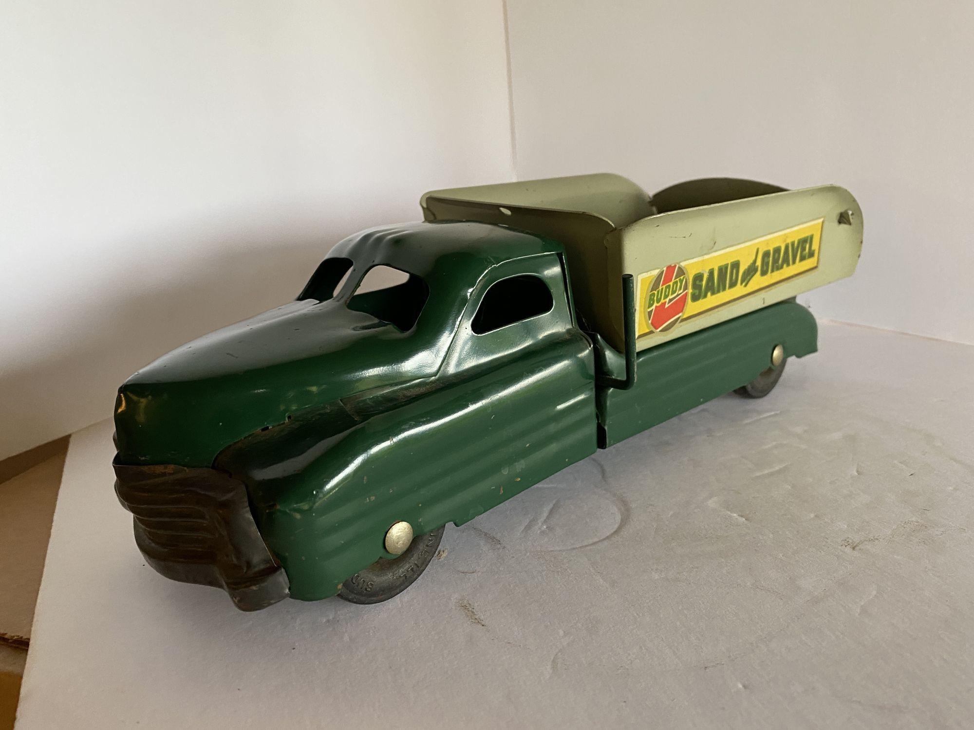 

Circa 1940 Buddy L Sand and Gravel dump truck, fully restored and repainted, in perfect shape and working condition, with some dirt spots on the wheels, minor discoloration on one wheel, and the original decals on both sides showing the markings