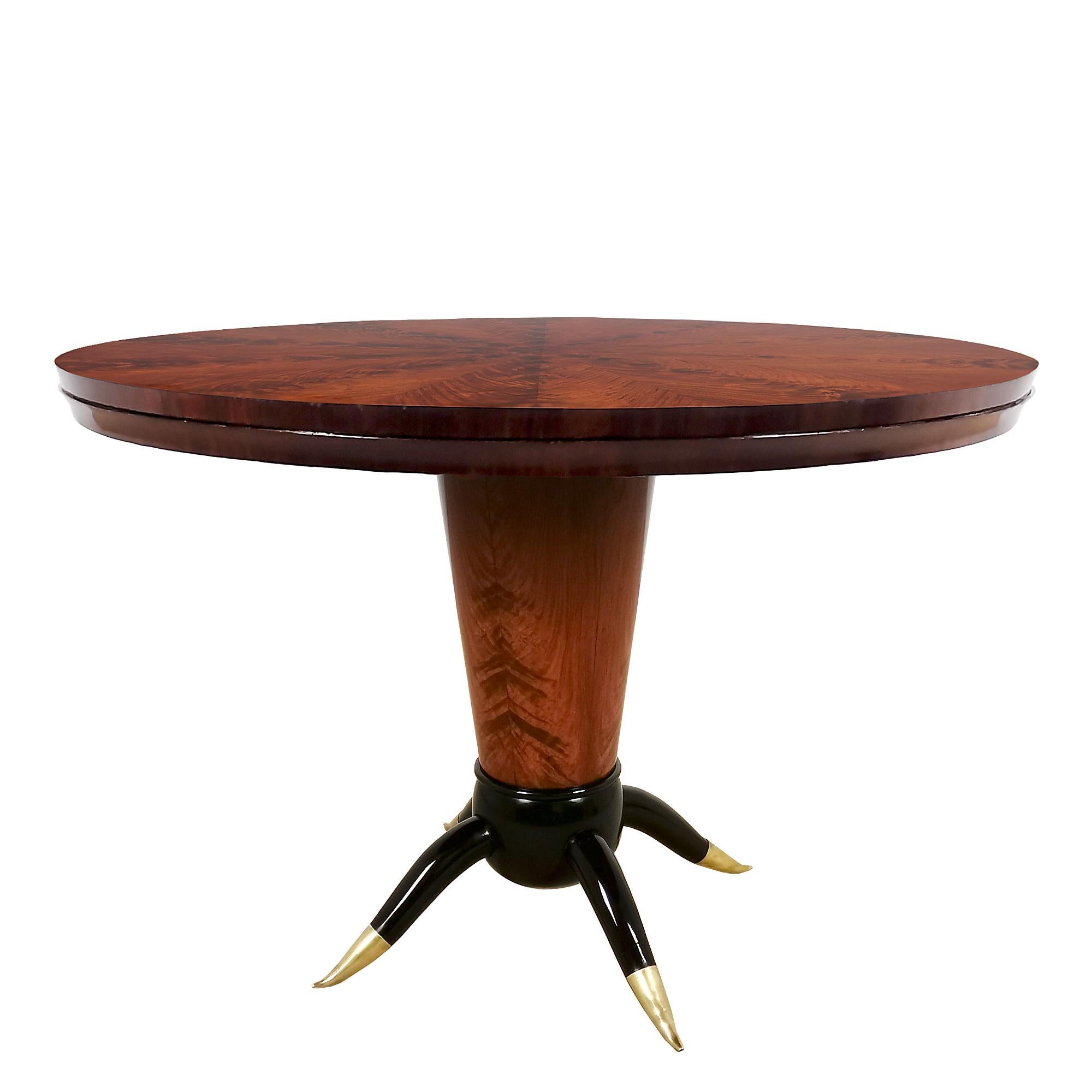 Center table in solid wood with burr mahogany veneer and stained beech base. On top an spectacular ten part star pattern veneer, French polish. Polished brass feet.

Italy c. 1940.