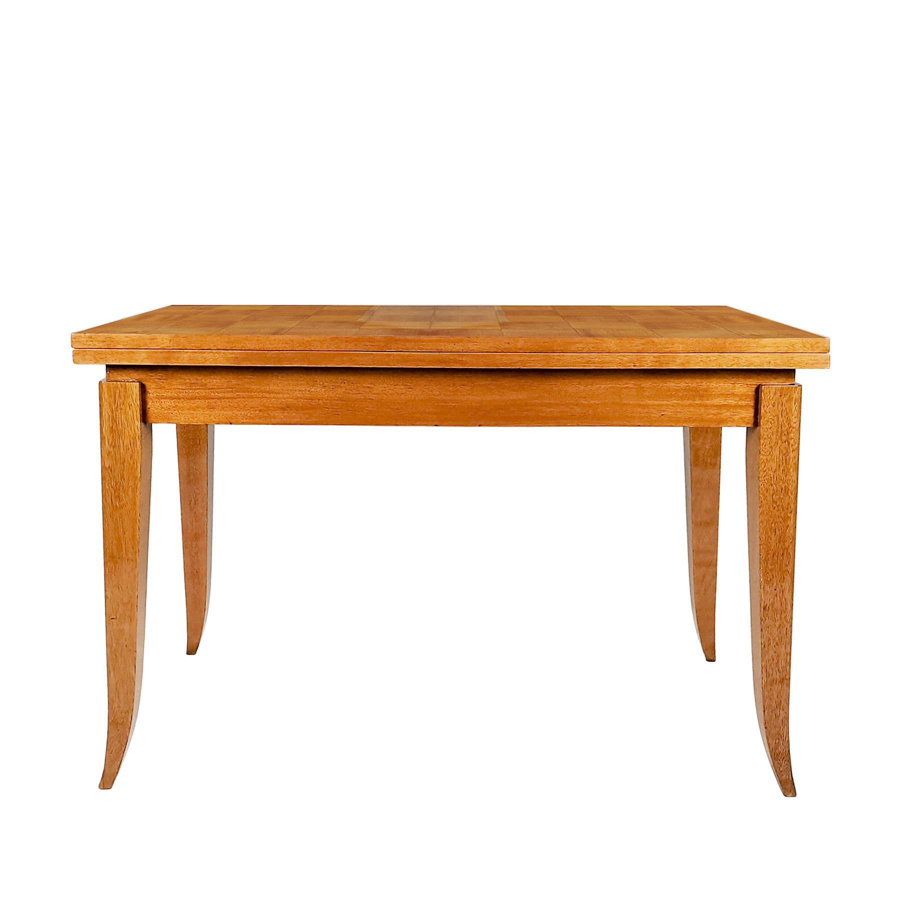 Game table, solid light mahogany base with a double flap top, with a light mahogany parquet veneer, French polish. Polished brass hardware.
France, circa 1940

Measurement open: 110 x 110 x 73 cm.