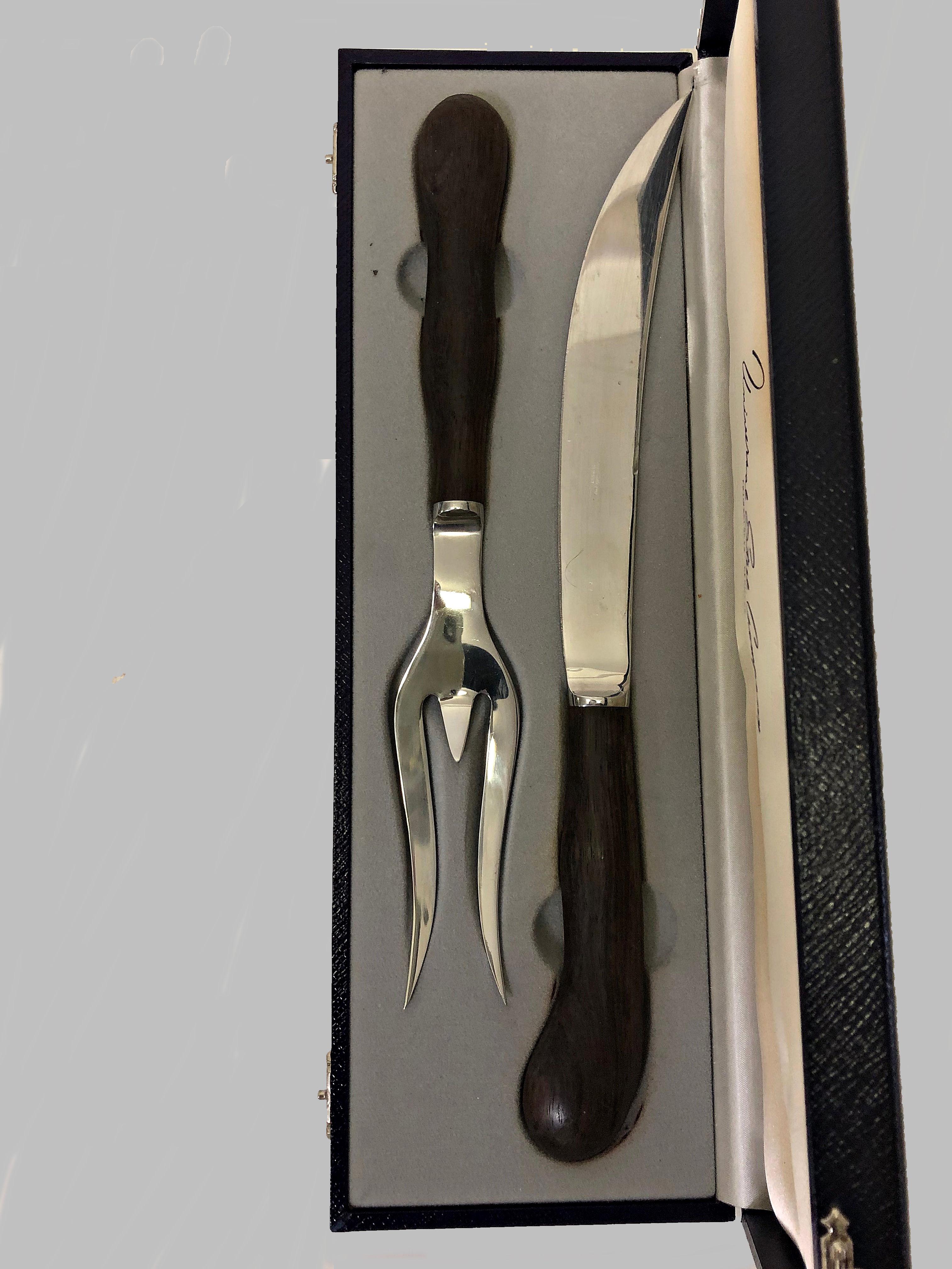Kay Bojesen. Danish sculptural carving set of cromed steel with handles of rosewood, in original box. Knife and box is marked USC. Universal Steel Company.

Seize cm./inch:

Knife: 34.5 / 13.6

Fork: 29.5 / 11.6