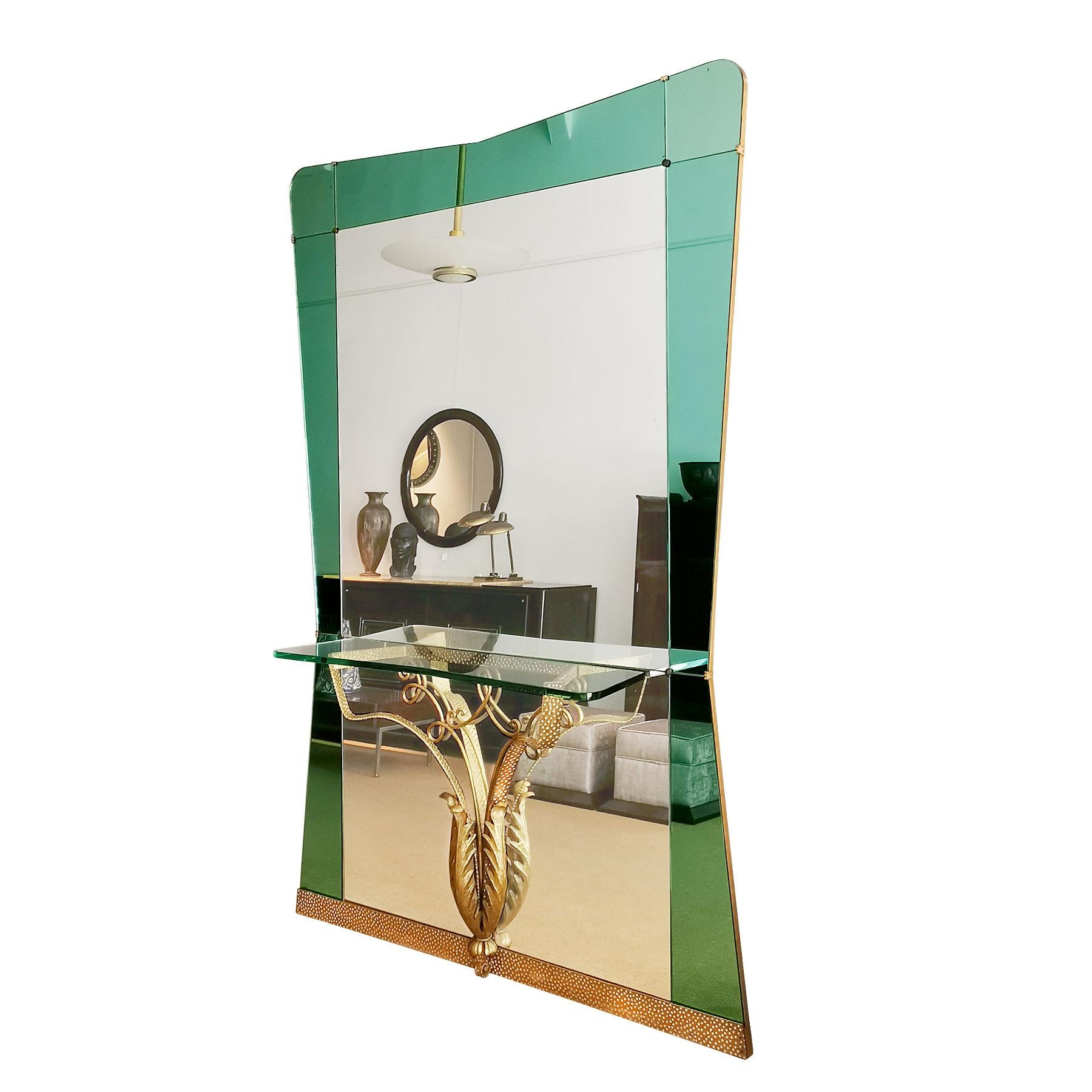 Large mirror-console, green mirror frame and partially hammered golden metal, thick glass console.

Design: Pierre Luigi Colli

Italy, circa 1940.