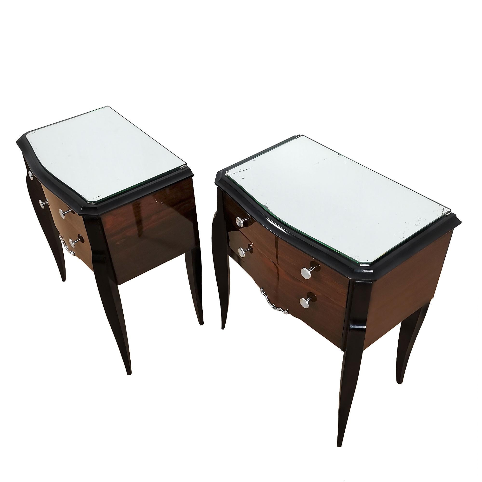 Pair of night stands with beech structure, stands and top black stained, mahogany veneer on sides and drawers, French polish. Original mirror on top (some oxidation).
France, c. 1940.