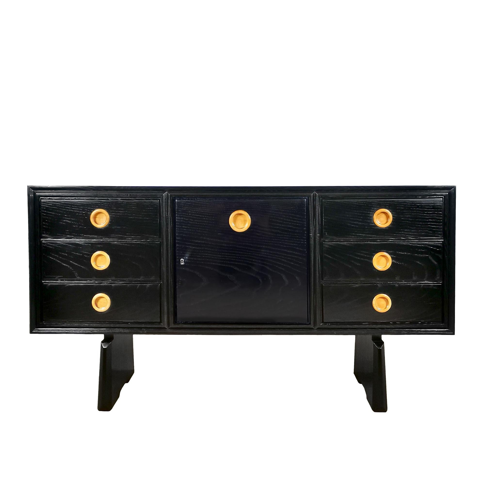 Small sideboard-bar cabinet, solid wood with open-pore treated oak veneered, dark chocolate stained and shellac finishing. Two sets of 3 drawers on either side of a door, opening onto the bar covered with micro-mirrors. 
Attributed to Paolo Buffa.