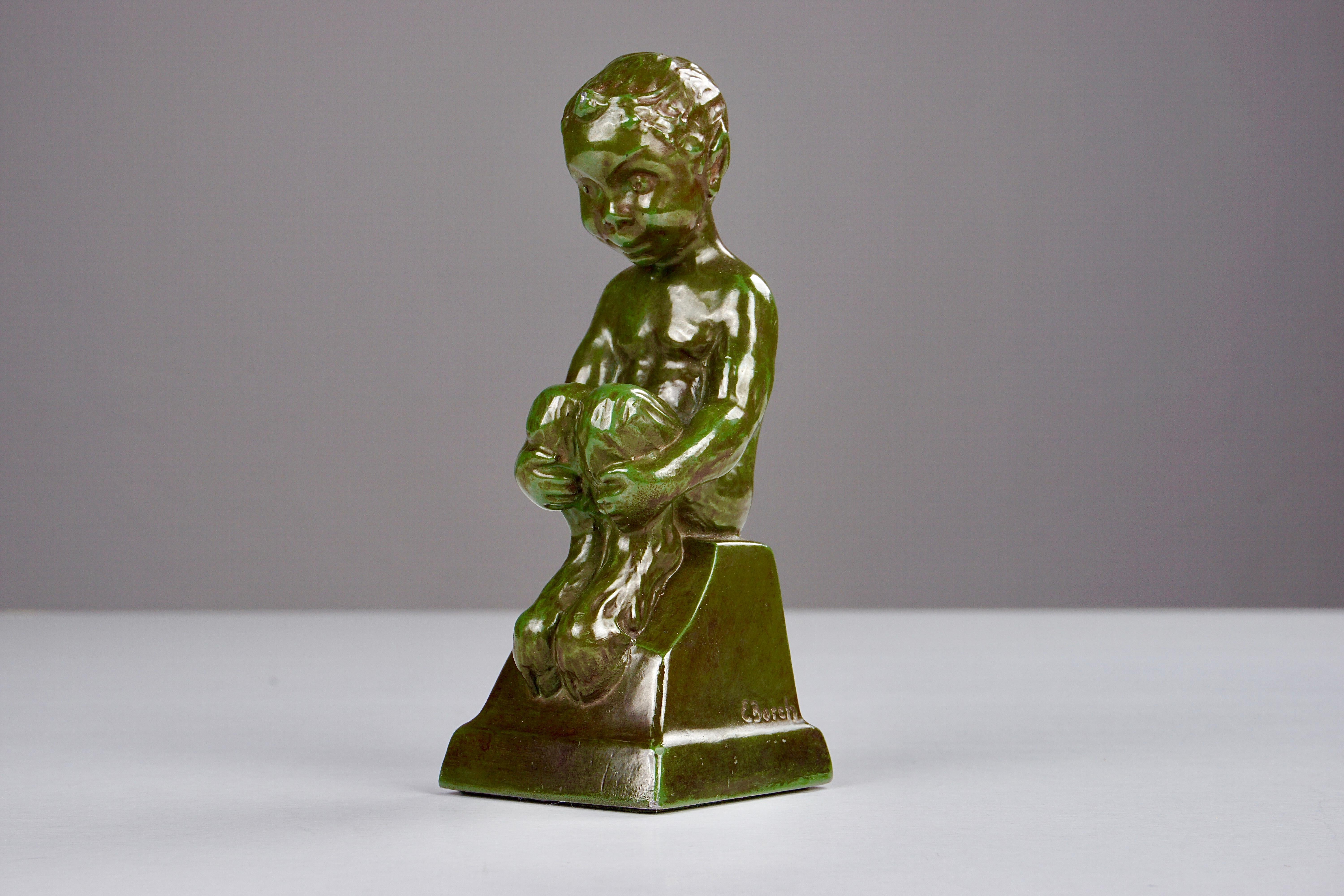 1940's Sitting Faun by Elena Borch made of Disco Metal by Just Andersen A/S

The sitting faun is in good vintage condition and marked with Just. Andersens triangle mark. 

Just Andersen 1884-1943 was born in Godhavn on the Disko island, which is