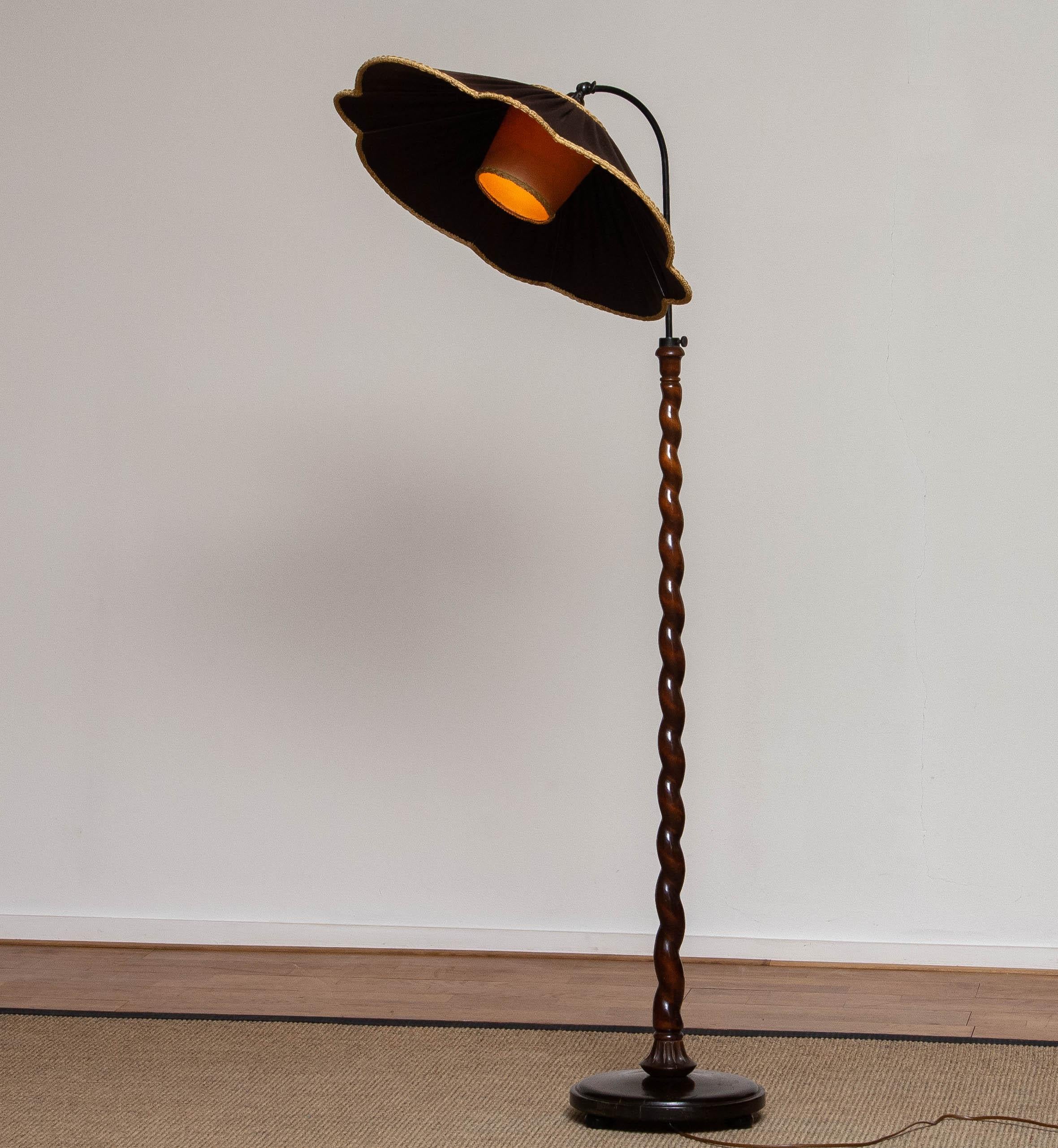 Beautiful and completely original 'spiral wood' organic floor lamp made in the 1940's in Sweden.
The lamp is adjustable in height as well as in angle. 
The 'flower shaped and typical Art Nouveau' with brown satin fabric shade is in perfect