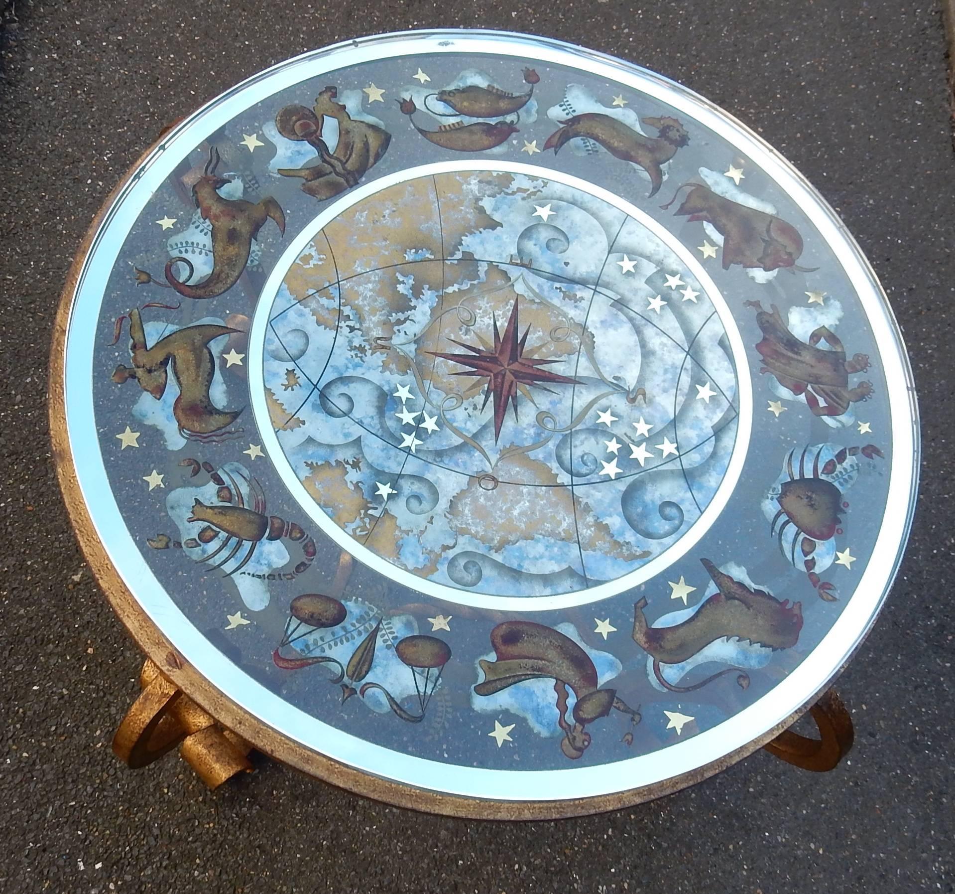 Coffee table or wrought iron pedestal table by Mercier for Poillerat and glass paving stone has decoration of Zodiac in églomisé style Ingrand or Pansart, condition of use, circa 1940-1950.