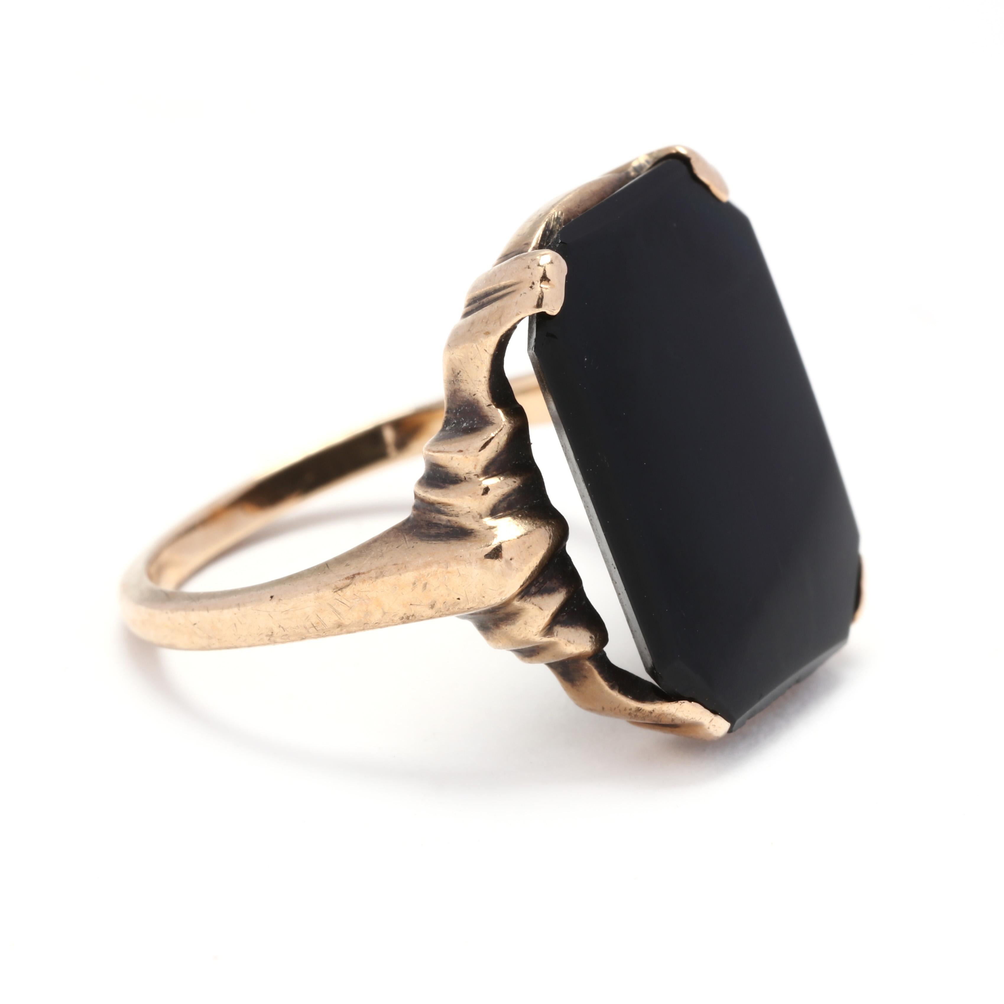 A 1940's 10 karat yellow gold and black onyx signet ring. This ring features a prong set, rectangular black onyx tablet with ridged detailing and a slightly tapered band.

Stones:
- black onyx, 1 stone
- rectangular tablet
- 15.8 x 12 mm

Ring Size