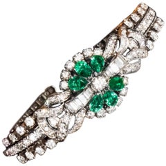 1940s 13 Carat Gubelin Platinum Emerald Diamond Flower Concealed Bracelet Watch