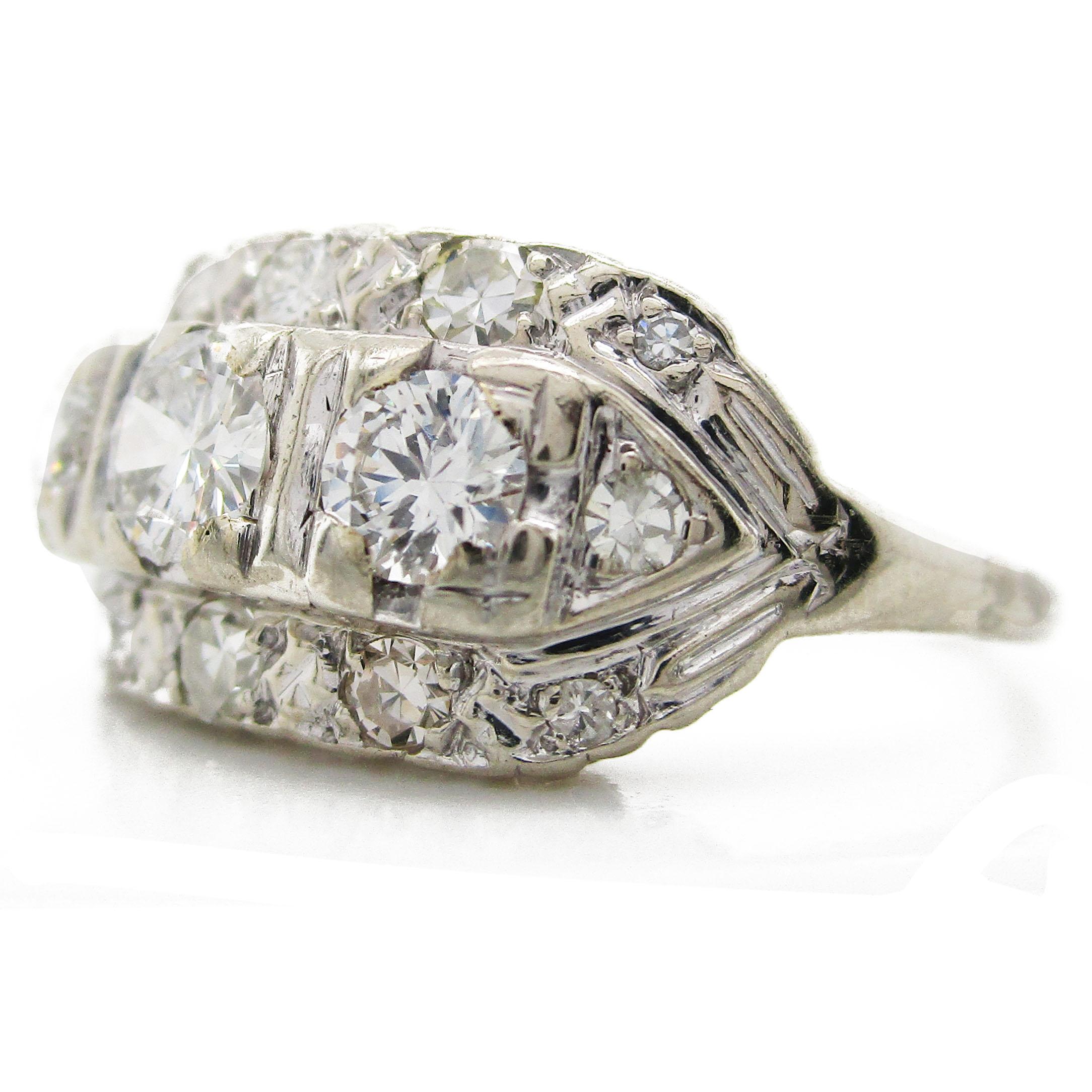 This absolutely gorgeous 1940's ring is in classic Deco , with three center stones surrounded by a diamond gallery! The three stone center is enhanced by the twelve diamonds surrounding it. The top and bottom are framed by four diamonds each, and