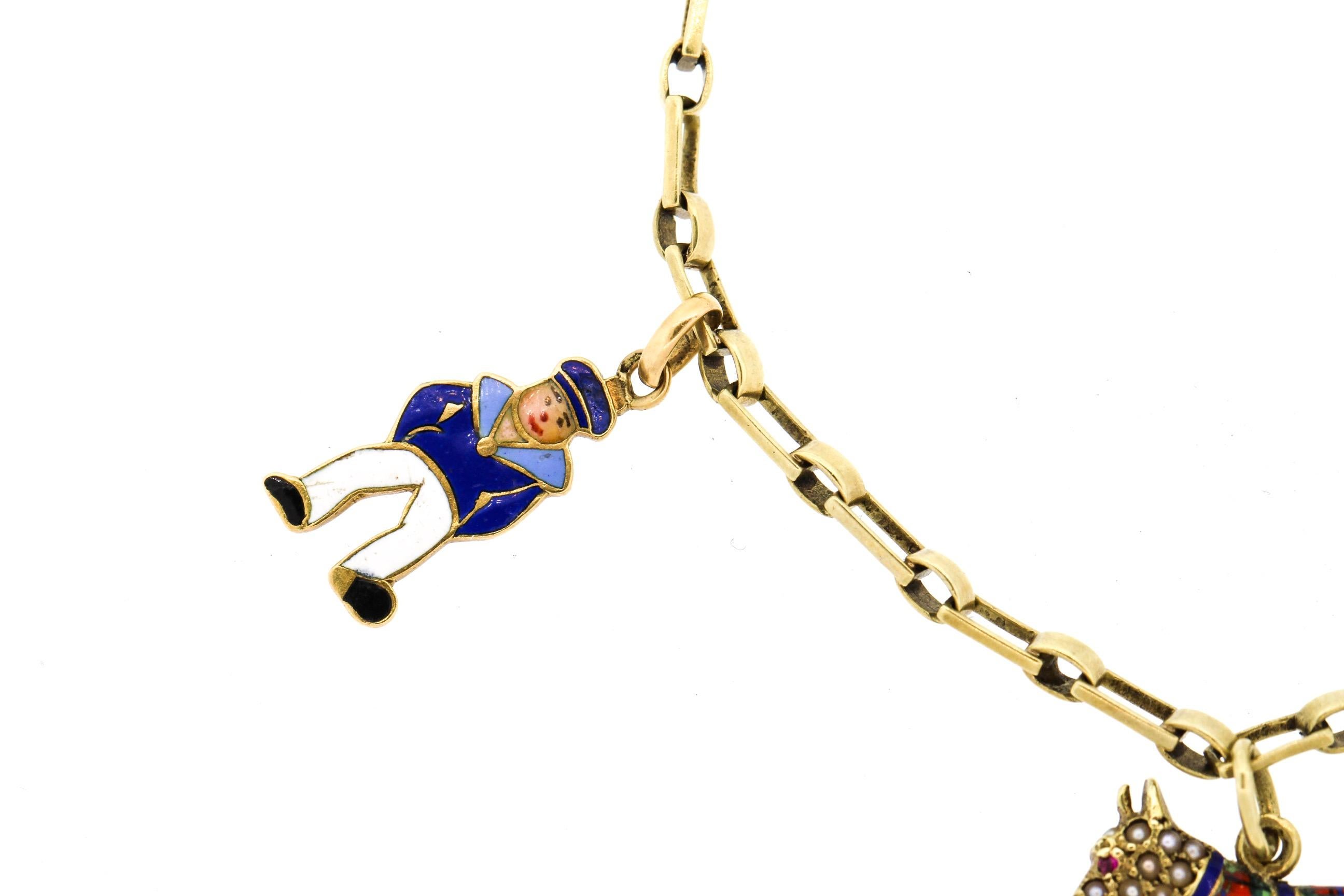 Whimsical vintage 1940s 14k yellow gold enamel charm bracelet. A 14k link bracelet suspends 5 enamel charms. One is an Aquarius zodiac charm, a man dressed like a sailor, and Scottie dog with tartan coat and pearls, a maiden carrying water, and a