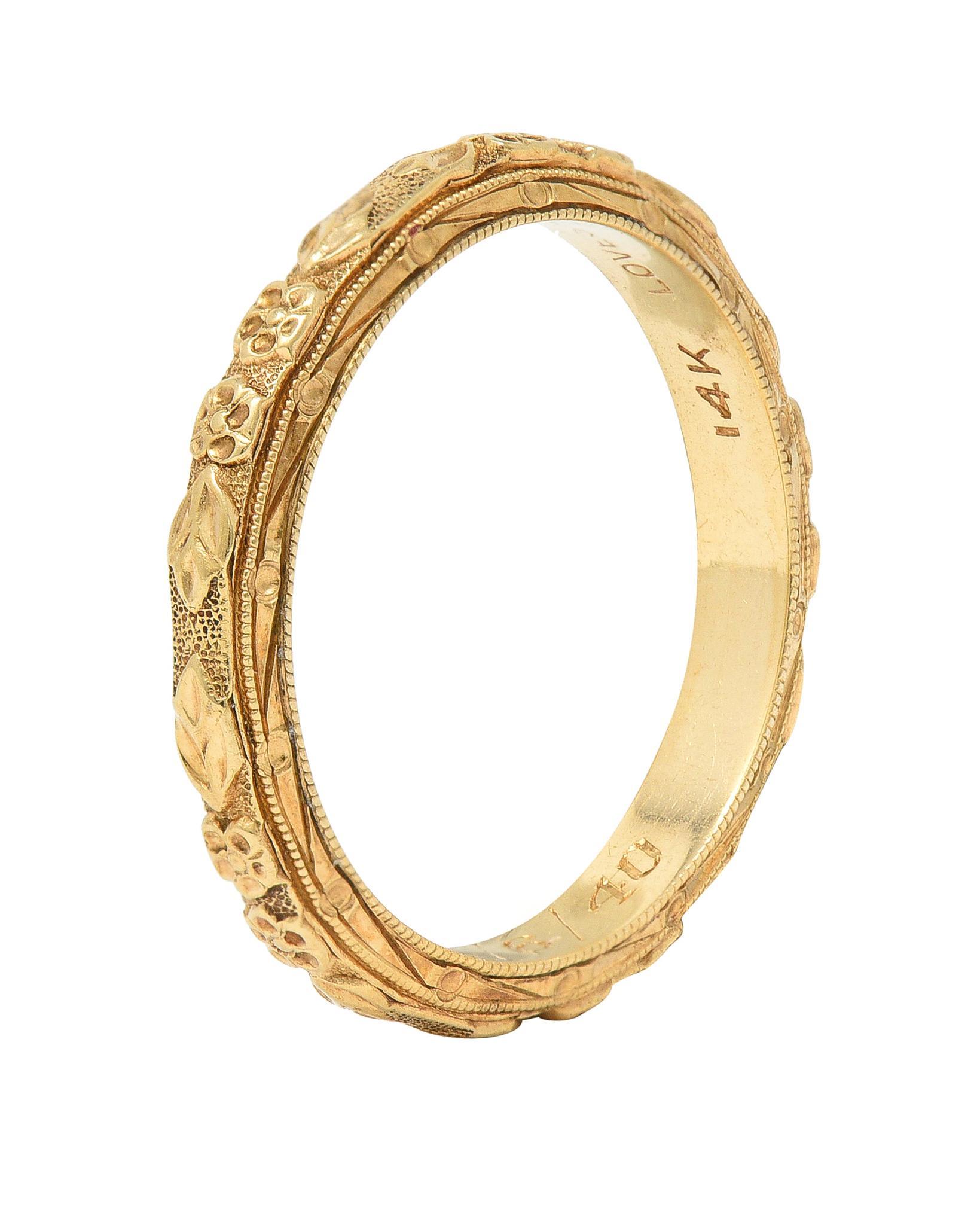Designed as a band ring with a raised orange blossom motif fully around
With milgrain detail edges and engraved details
With an engraved twist motif profile
Inscribed 'Raymond to Fama 12/6/40 '
Stamped for 18 karat gold and tested as platinum
With