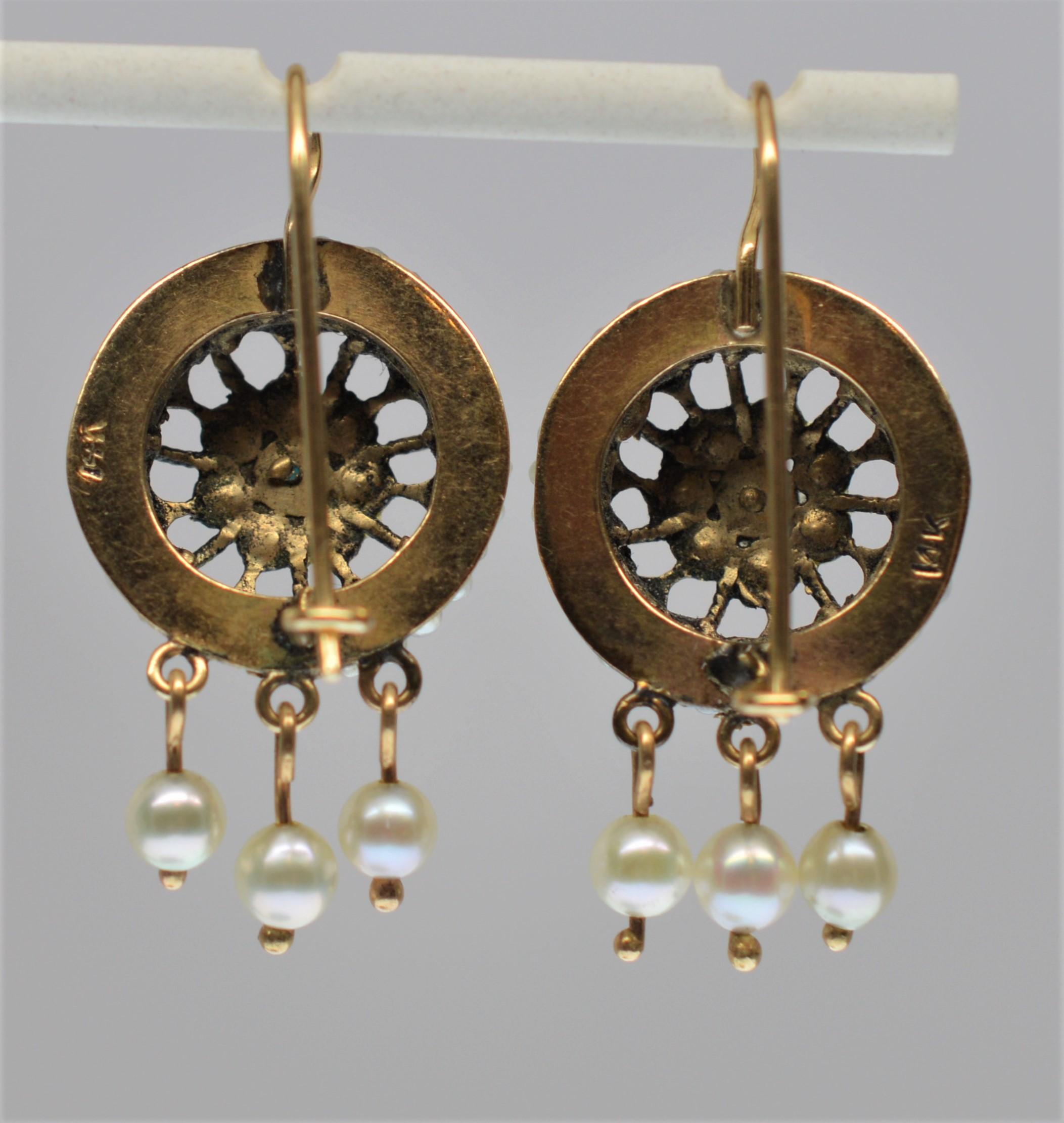 In fourteen karat (14k) yellow gold, this fabulous circa 1940's pair of earrings fits today's popular Bohemian style while retaining the craftsmanship of the vintage period in which they were created. Gold filigree medallions are decorated with