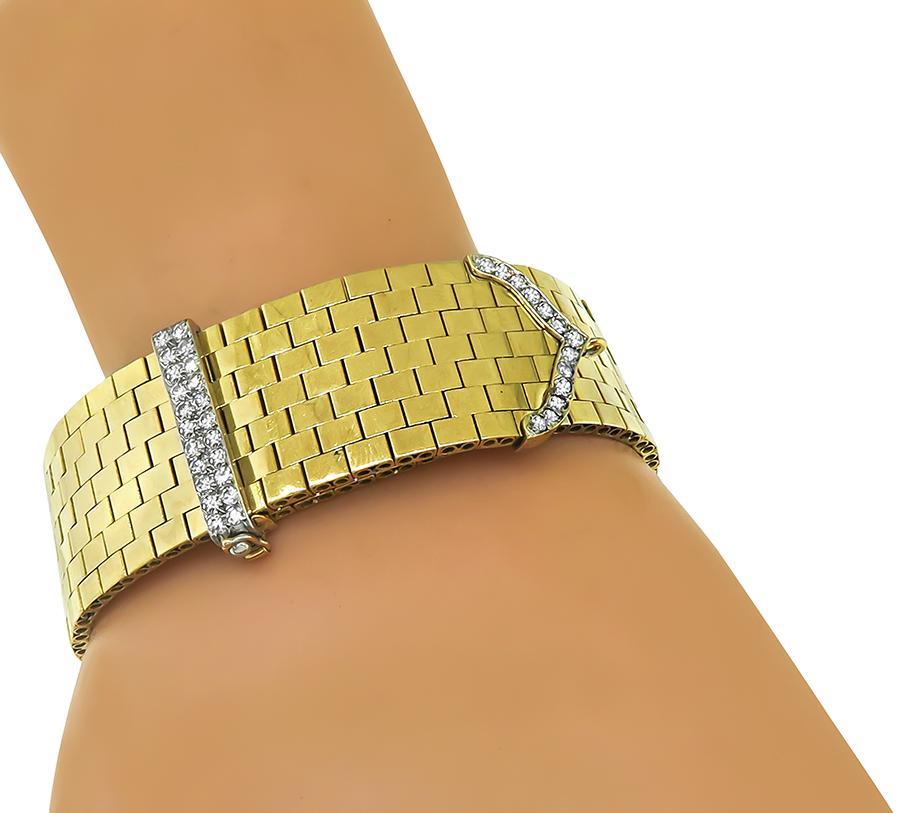 This is a fabulous 18k yellow and white gold bracelet from the Retro era. The bracelet is set with sparkling round cut diamonds that weigh approximately 1.40ct. The color of the diamonds is G with VS clarity. The bracelet measures 20.5mm in width
