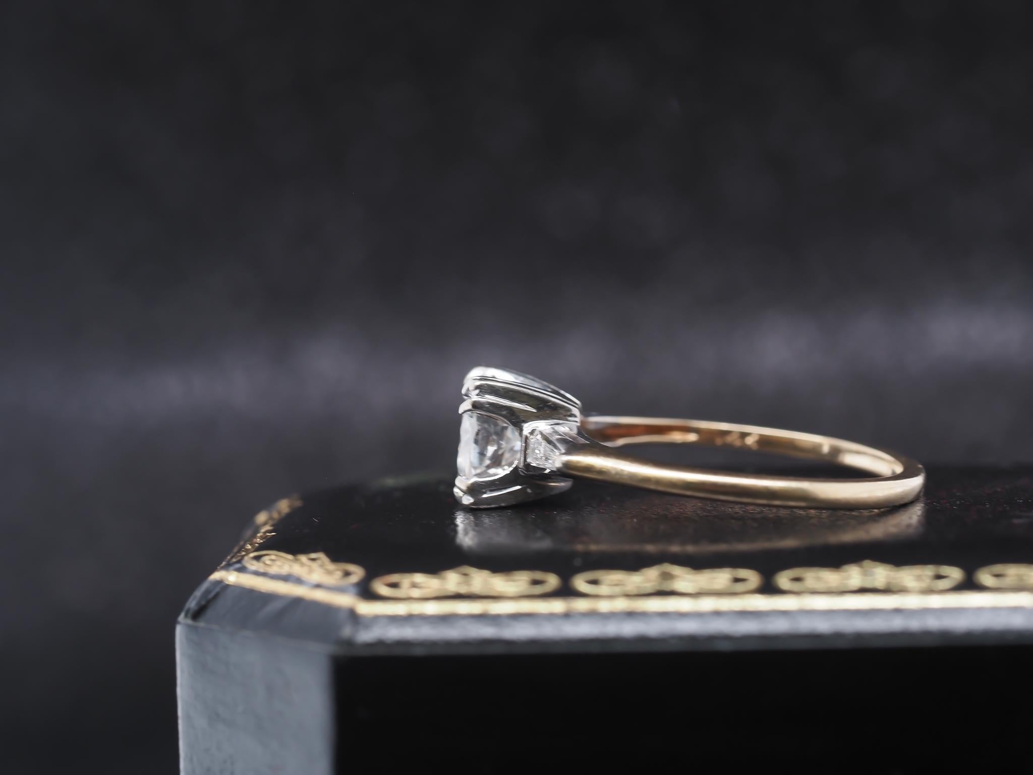 Year: 1940s

Item Details:
Ring Size: 6.75 (Sizable)
Metal Type: 14K Yellow Gold [Hallmarked, and Tested]
Weight: 2.6 grams

Diamond Details:

Center Diamond: 1.15ct, Old European Brilliant, H Color, SI2 Clarity

Side Stone Details: Antique Tapered