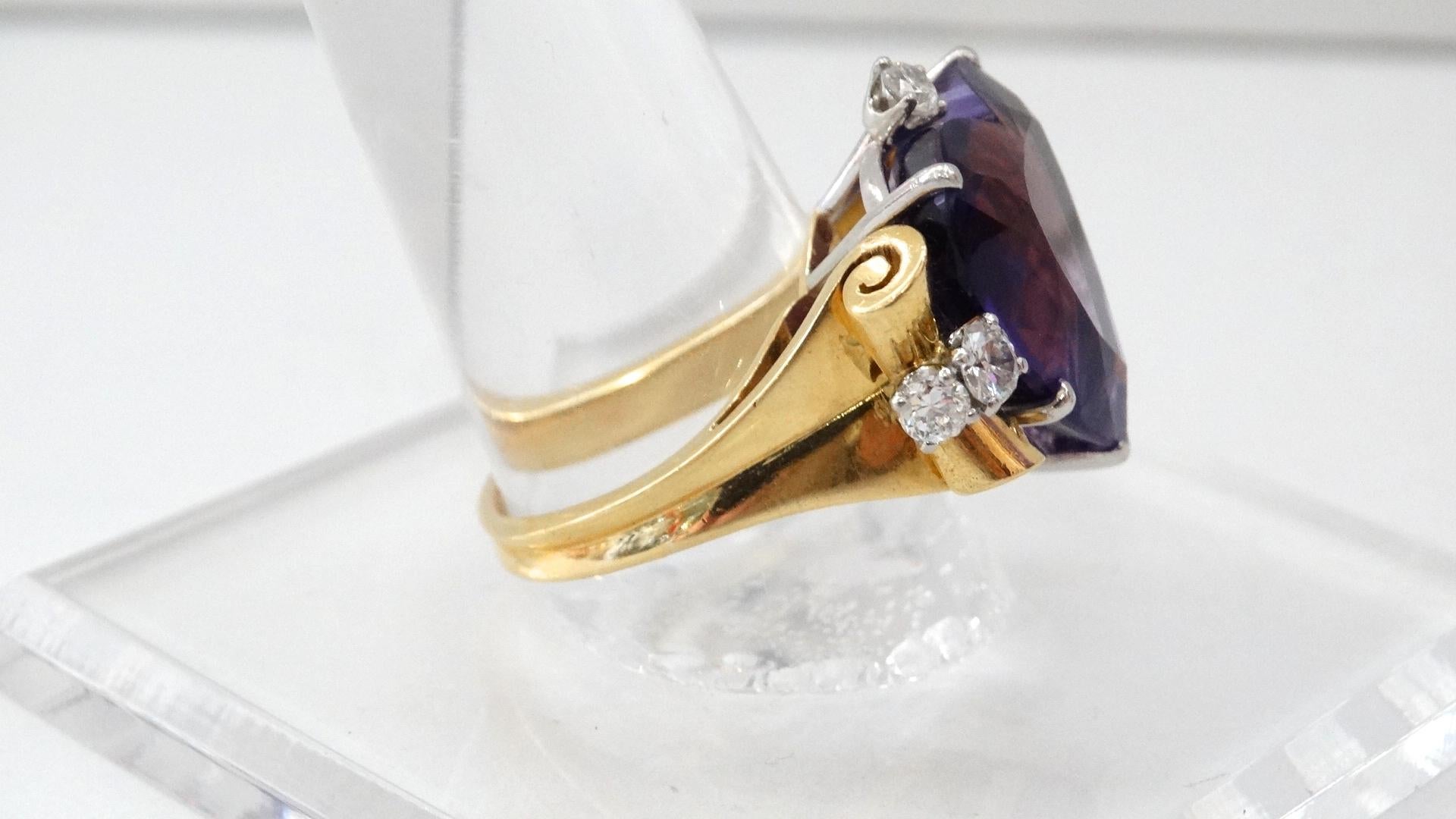 A beautiful 1940s ring featuring a 14K yellow gold band with scroll shaped sides. Yellow gold setting is composed of one heart shaped Amethyst, medium tone violet, and three round beautifully cut .09 Cts diamonds. Also includes two round cut .14 Cts