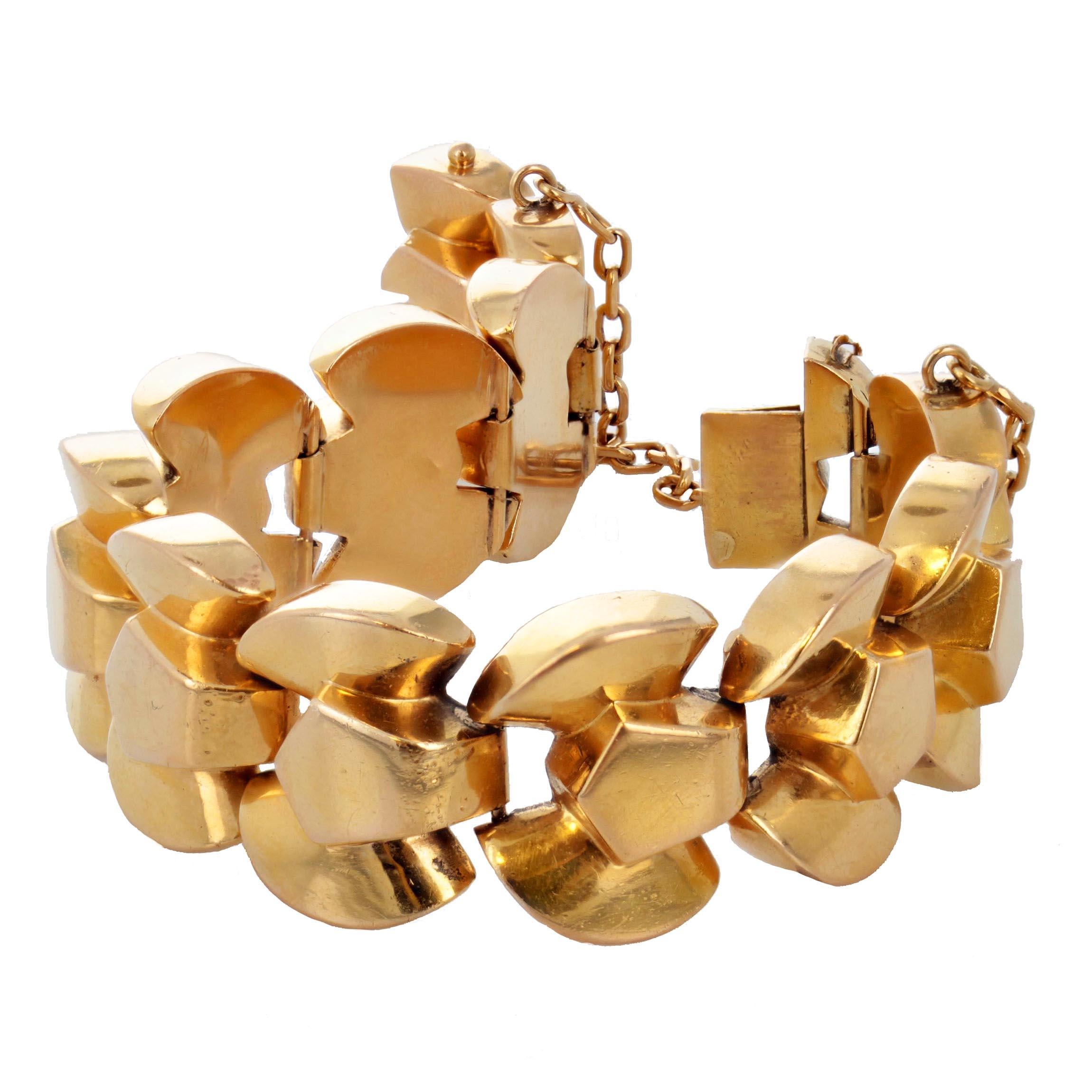 This retro tank bracelet from the 1940's is made of expertly crafted bold links in 18 karat yellow gold. With a safety chain and French control marks for 18 karat gold. There is a small ding on one of the links, but it does not take away from it's