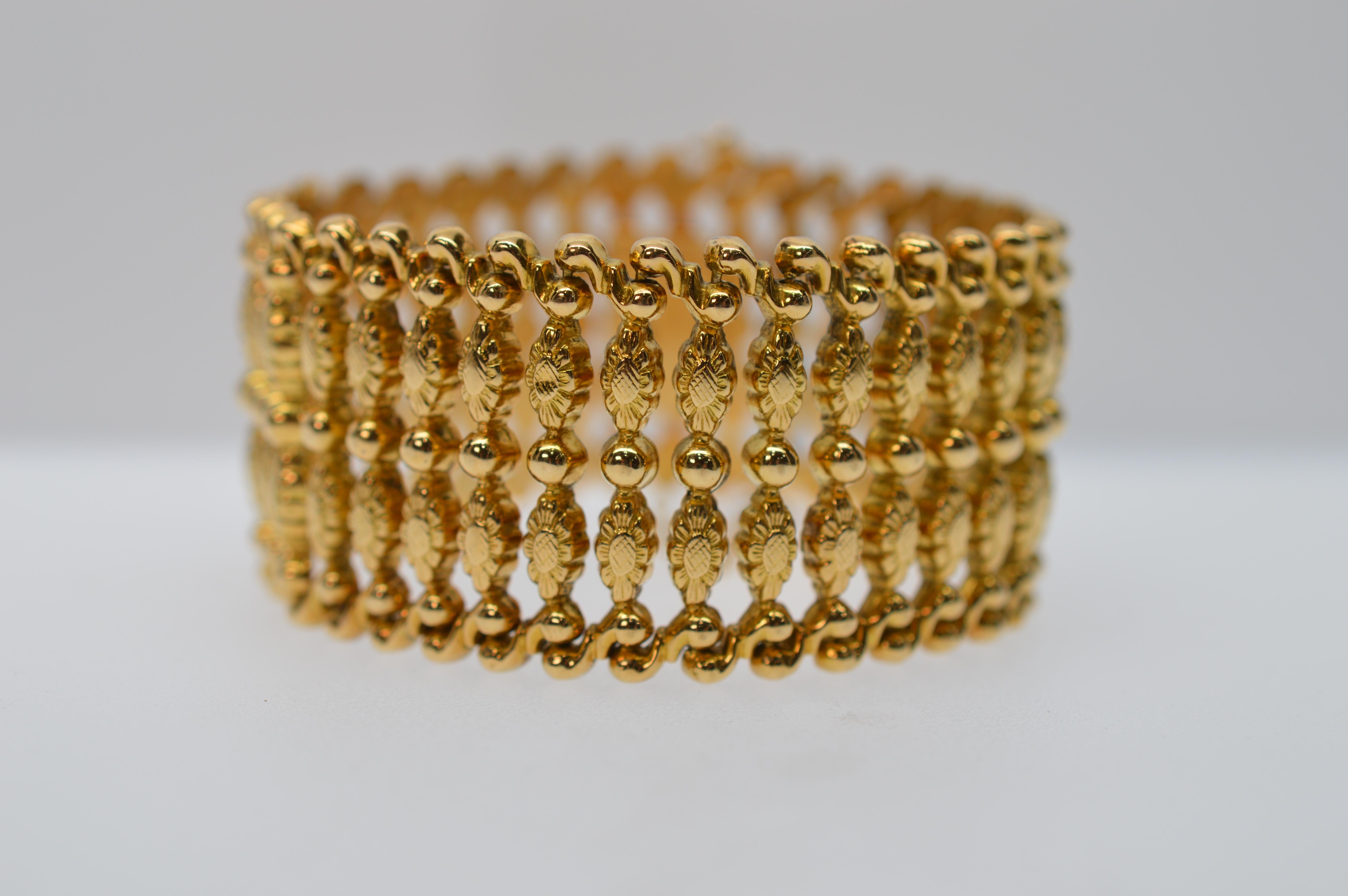 Fabulous circa 1940's in eighteen karat (18K) yellow gold, this retro style ladder bracelet is an undeniable treasure. Measuring 7-1/2 inches long and a remarkable 1-1/4 inches wide, the multiple .750 gold links of this bold piece present a cuff