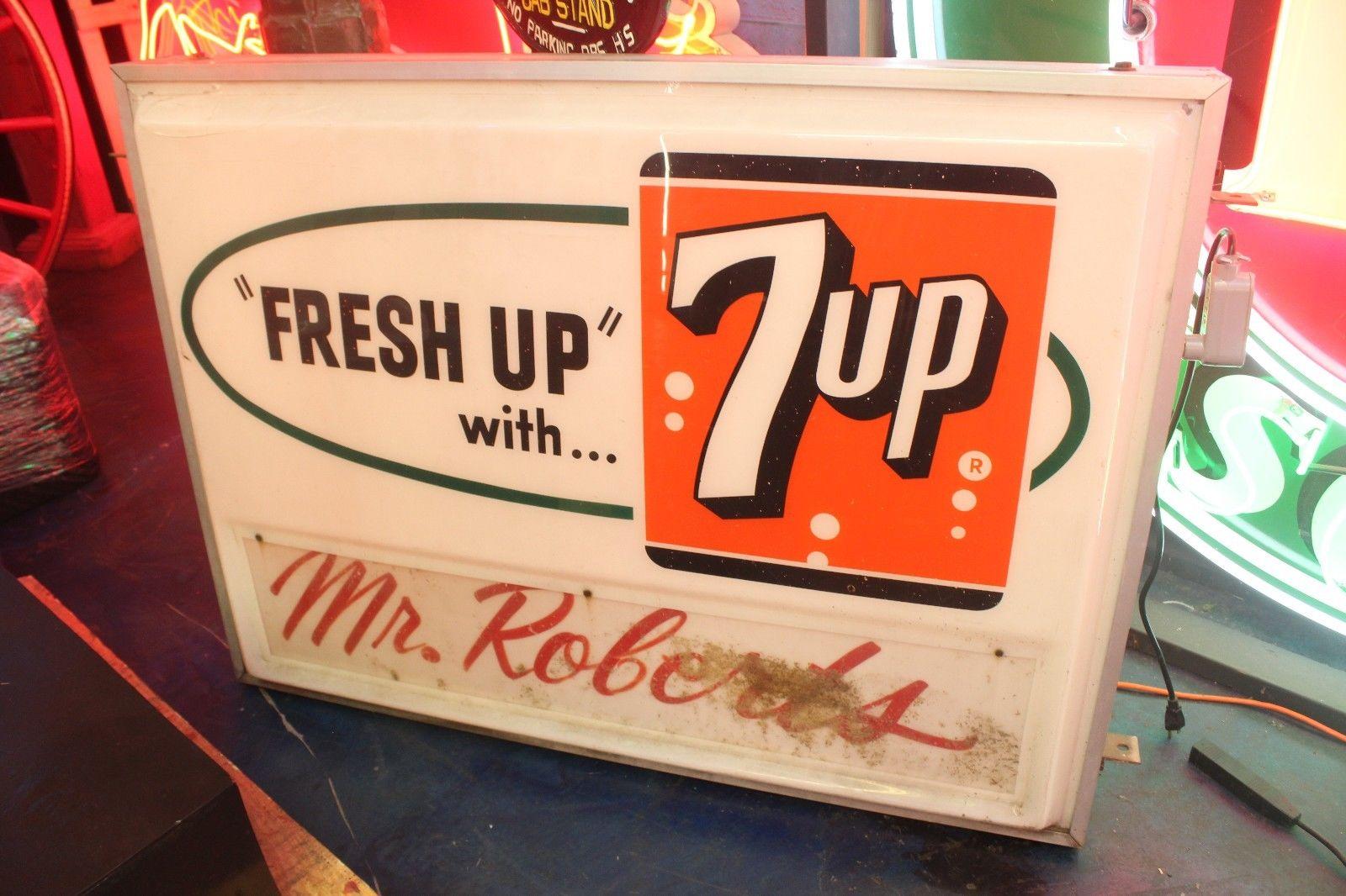 Sign by Everbrite. Mostly found outside hanging from the side of a building to advertise the grocery store and 7-up. Initially advertised as a cure for hangovers (